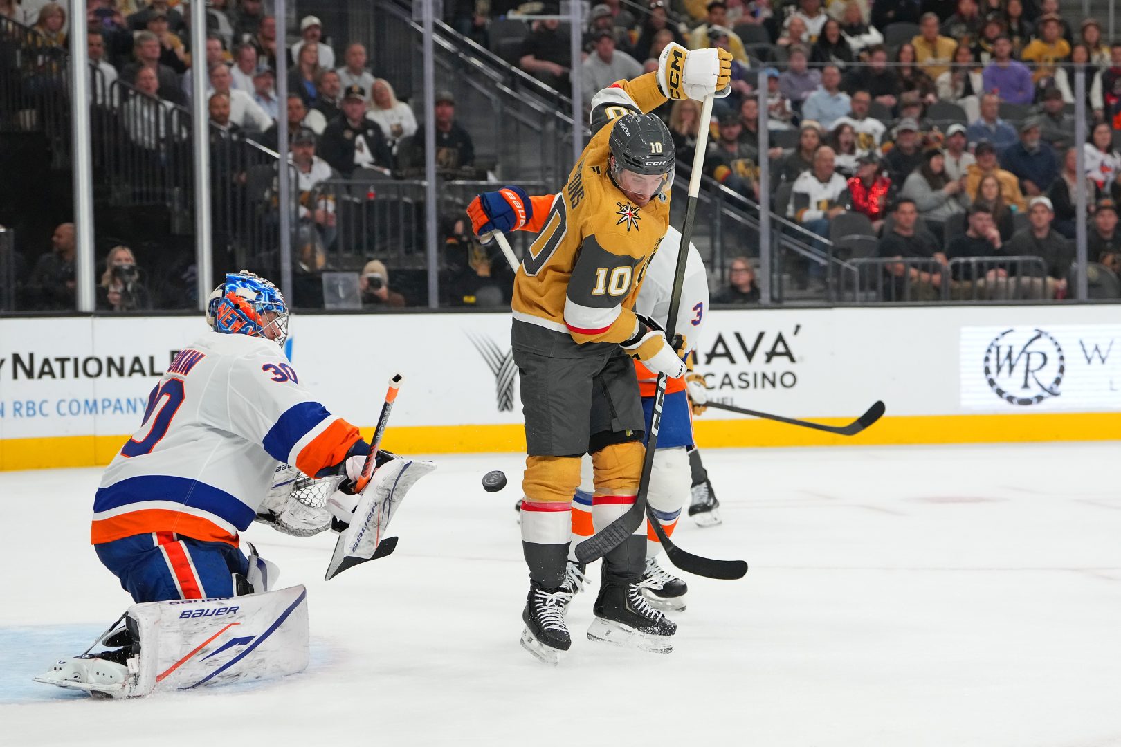 New York Islanders goalie Ilya Sorokin makes a save as Vegas Golden Knights forward Colton Sissons tries to deflect the puck during the third period in Las Vegas.