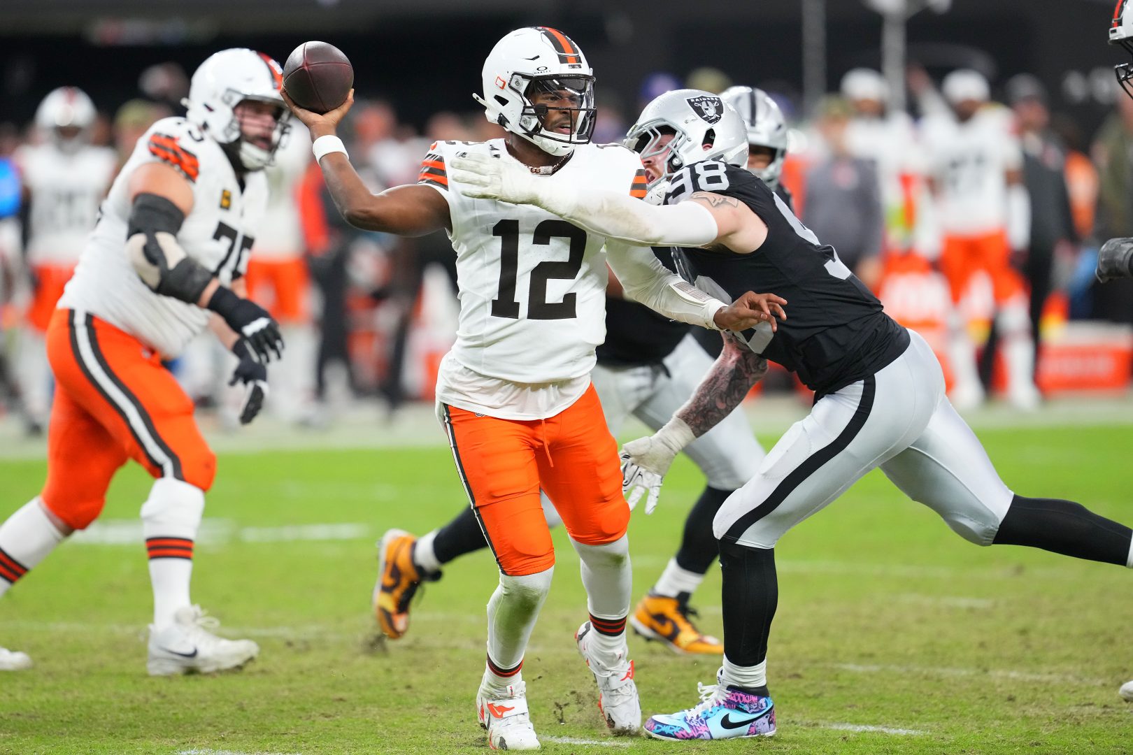 Maxx Crosby pressures Browns quarterback Shedeur Sanders while wearing Stand Up for Pits My Cause My Cleats during a 2025 Raiders game at Allegiant Stadium.