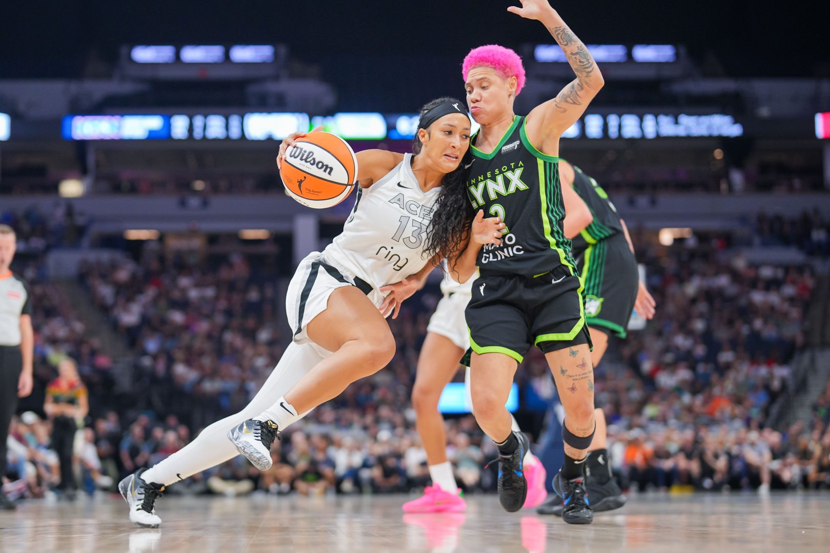 Las Vegas Aces guard Aaliyah Nye dribbles as Minnesota Lynx guard Natisha Hiedeman defends at Target Center.