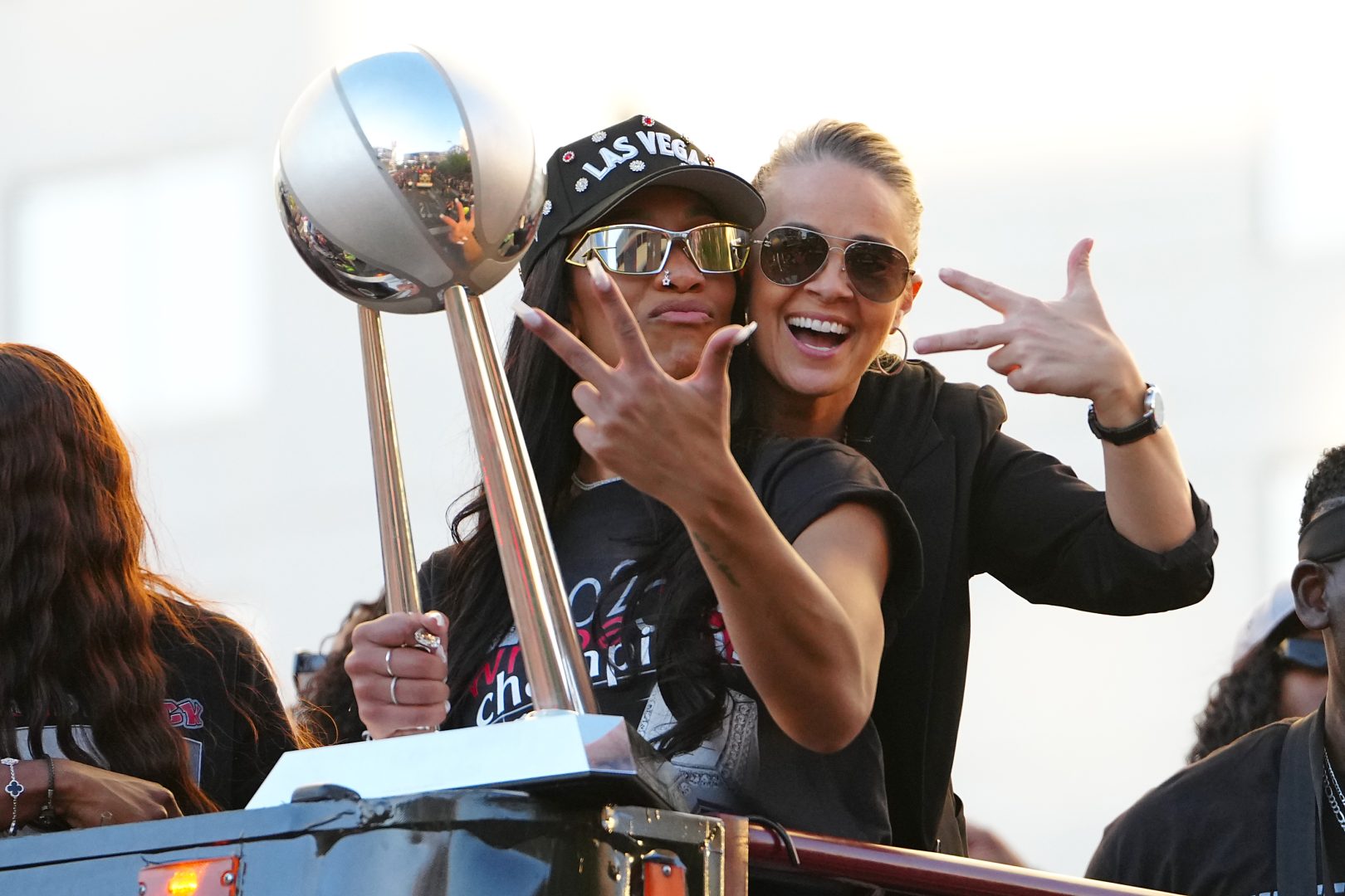 Las Vegas Aces center A'Ja Wilson (22) and head coach Becky Hammond pose for a photo during the 2025 WNBA Championship parade at Toshiba Plaza
