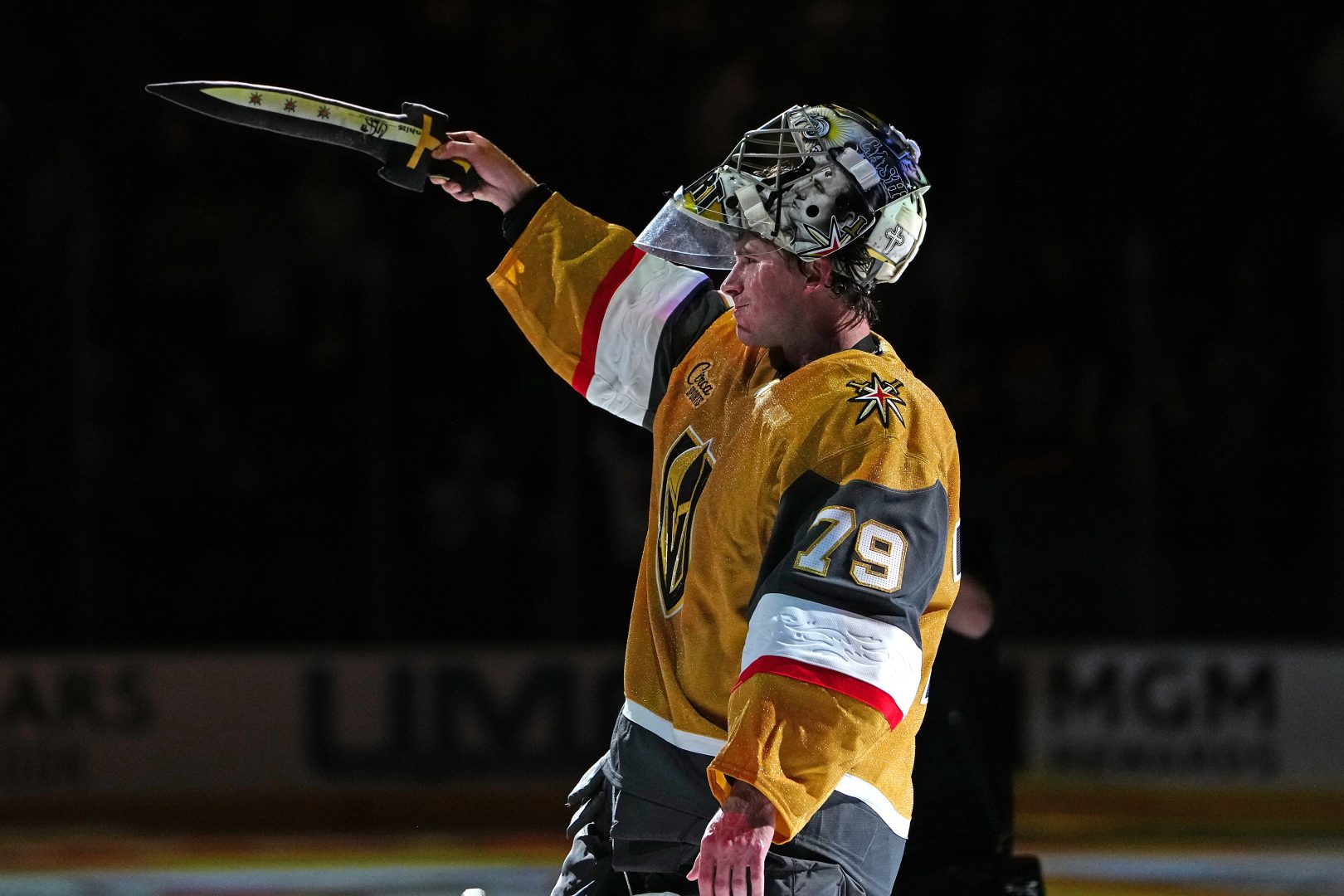 Vegas Golden Knights goalie Carter Hart raises the golden sword after being named Third Star of the Game following a 4-3 shootout win over the Chicago Blackhawks at T-Mobile Arena on Dec. 2, 2025.