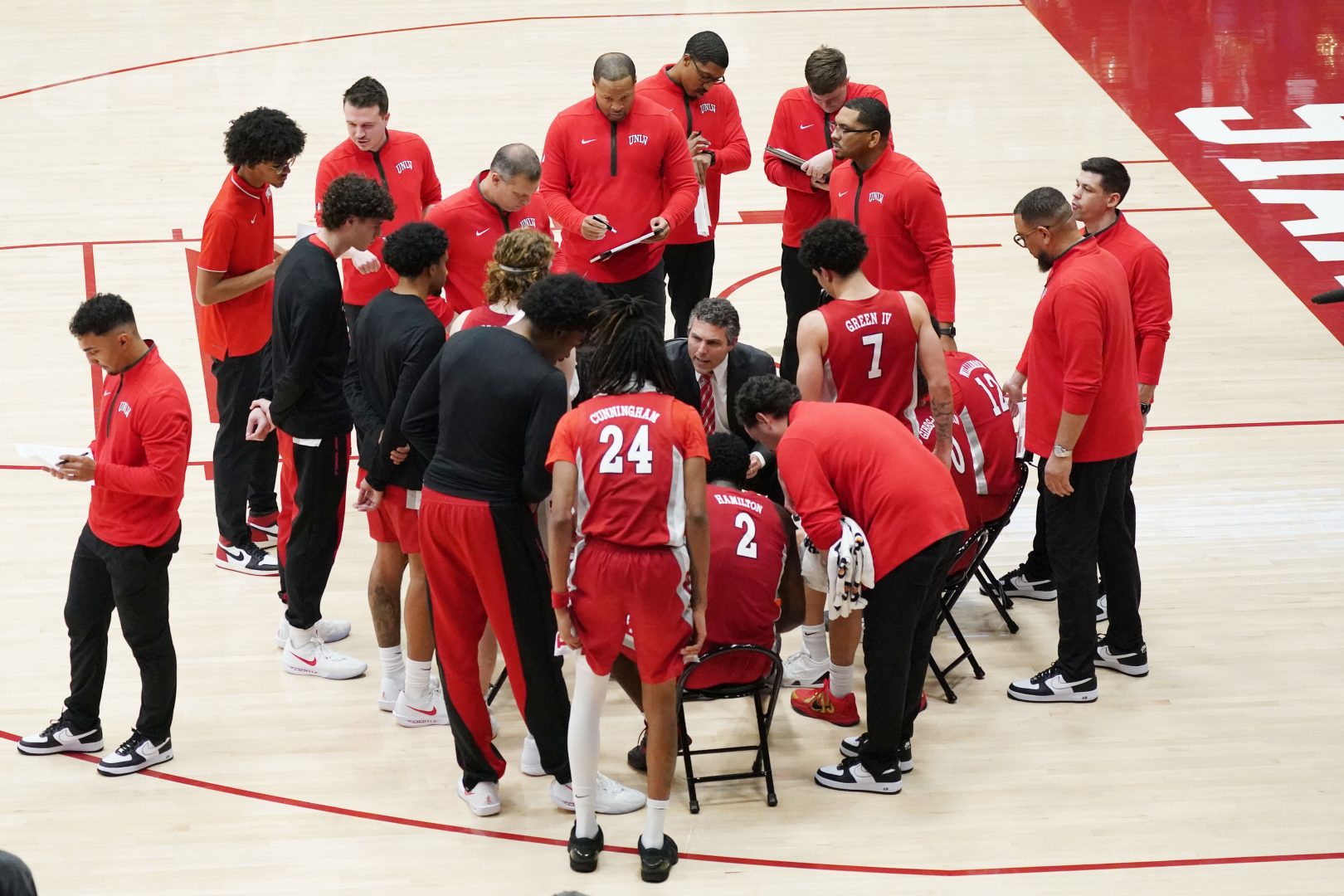 UNLV Runnin' Rebels head coach Josh Pastner talks with his team during a timeout in the second half against the Stanford Cardinal at Maples Pavilion.