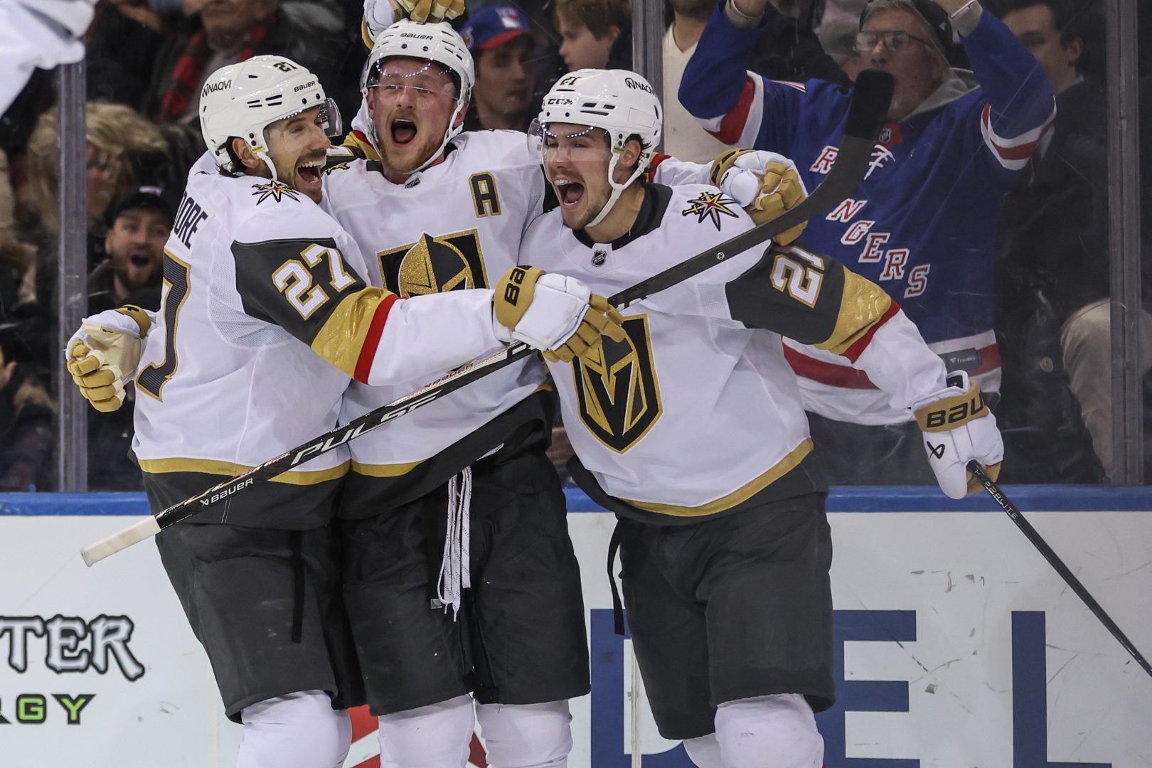Jack Eichel celebrates his overtime game-winning goal with Shea Theodore and Brett Howden against the New York Rangers at Madison Square Garden.
