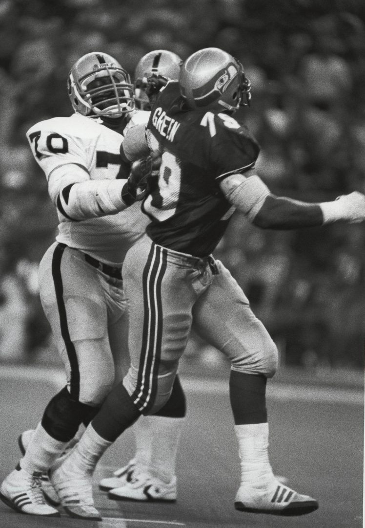 File photo: Los Angeles Raiders lineman Henry Lawrence (70) blocks Seattle Seahawks defensive end Jacob Green (79) at the Kingdome.