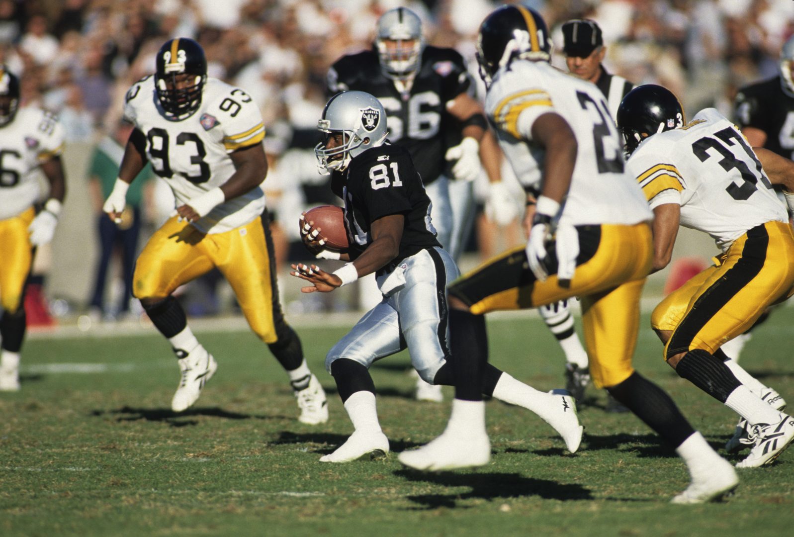 File photo: Los Angeles Raiders returner Tim Brown (81) runs with the ball against the Pittsburgh Steelers at Los Angeles Memorial Coliseum.