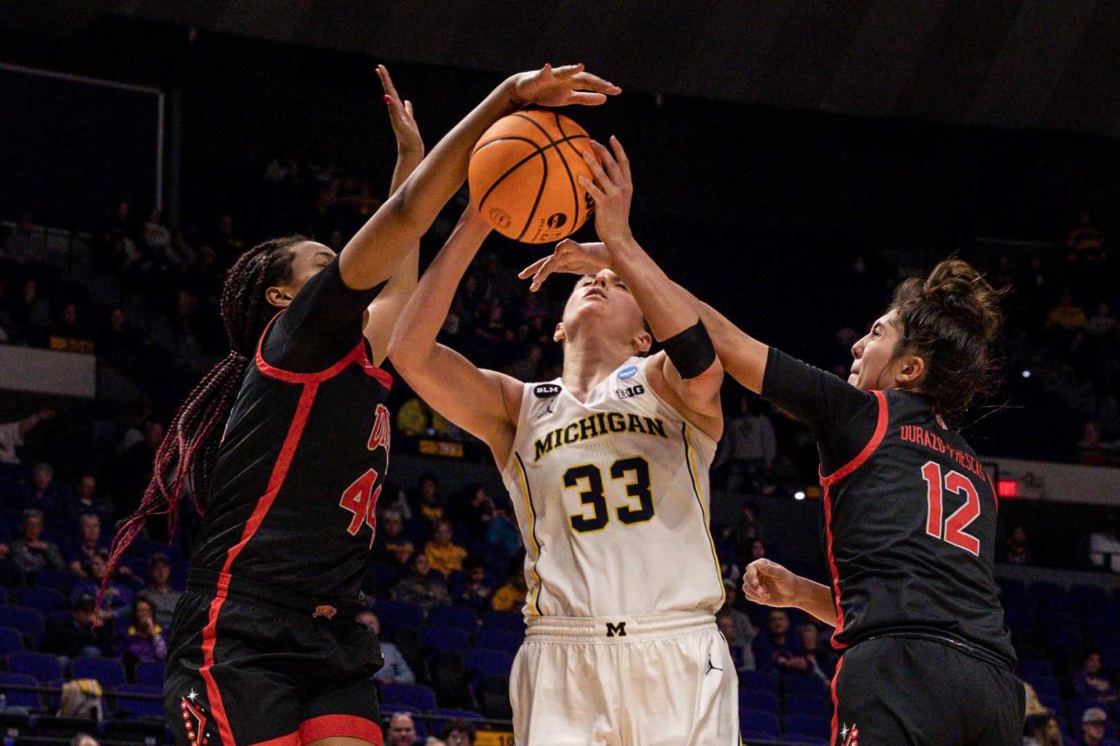 Michigan Wolverines forward Emily Kiser (33) is fouled by UNLV Lady Rebels guard Alyssa Durazo-Frescas (12) and forward Alyssa Brown (44) during the second half at Pete Maravich Assembly Center.
