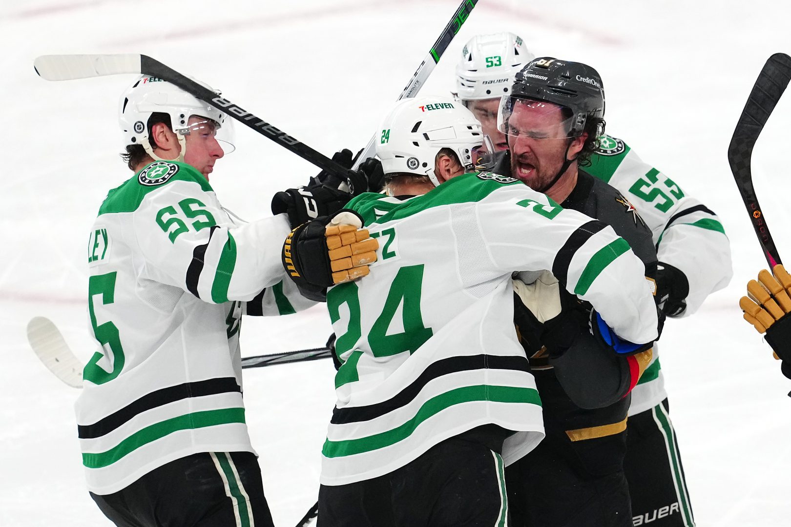 Dallas Stars center Wyatt Johnston and Roope Hintz confront Golden Knights right wing Mark Stone during a game at T-Mobile Arena.