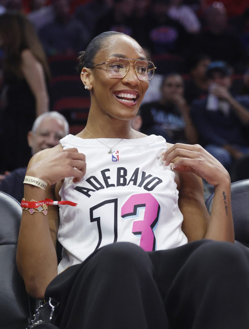 WNBA player A'ja Wilson shows off her Miami Heat Bam Adebayo jersey before the game between the Miami Heat and the Golden State Warriors at Kaseya Center.