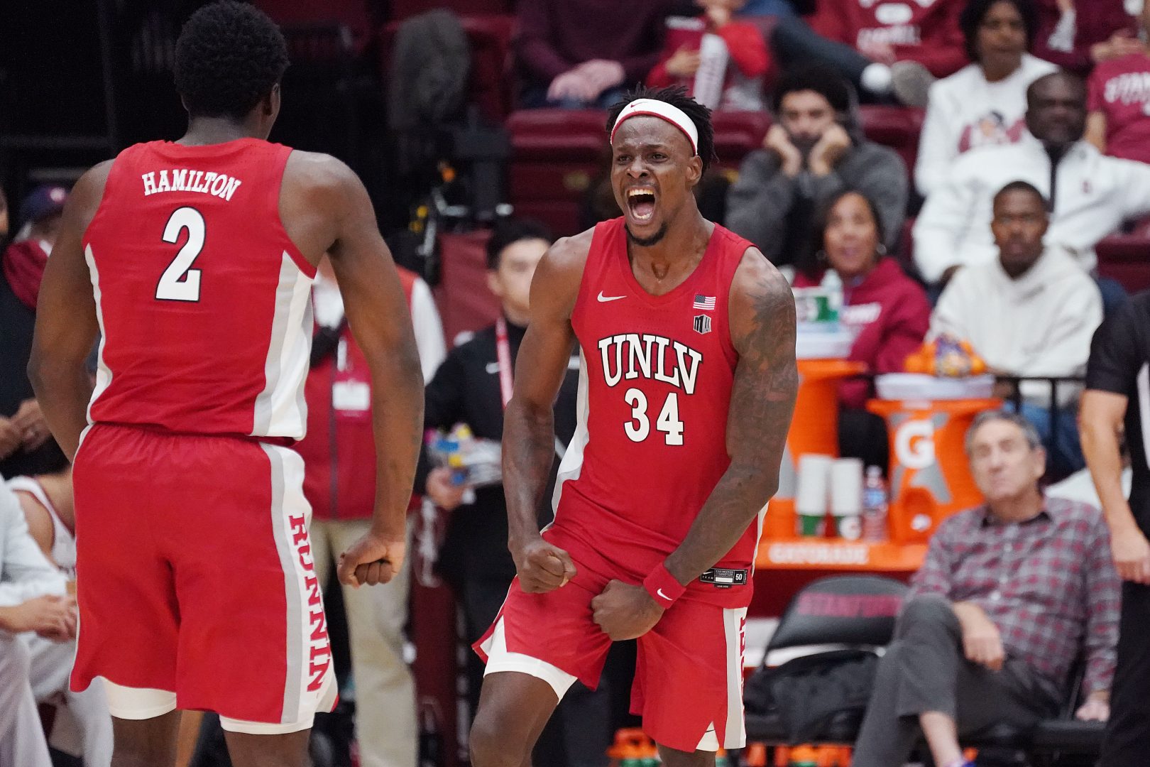 UNLV Runnin' Rebels center Emmanuel Stephen (34) celebrates with UNLV Runnin' Rebels forward Kimani Hamilton (2) after a basket at the buzzer at the end of the first half at Maples Pavilion.
