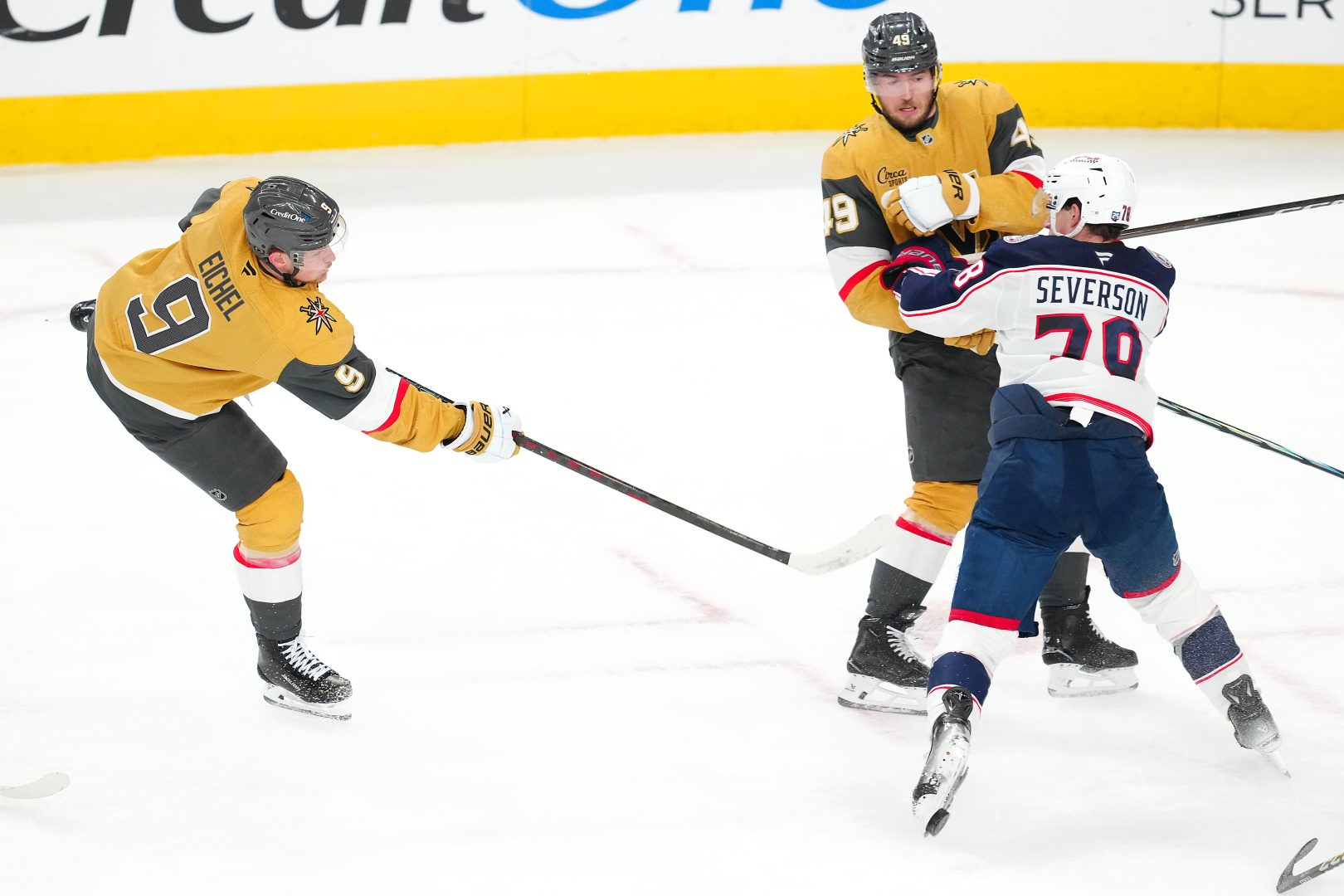 Vegas Golden Knights center Jack Eichel shoots as Blue Jackets defenseman Damon Severson blocks the attempt in the third period at T-Mobile Arena.