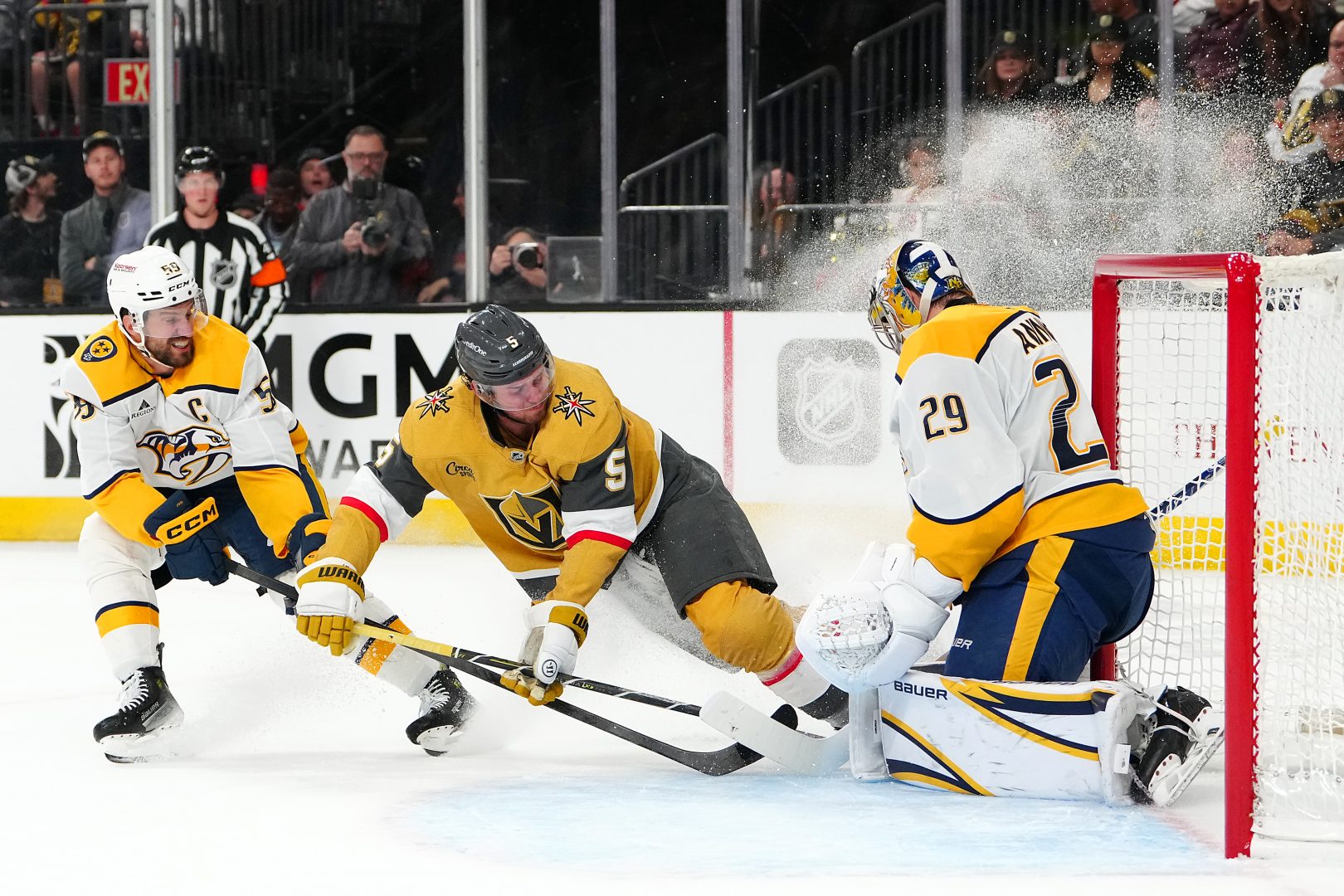 Nashville Predators goalie Justus Annunen makes a save as Vegas Golden Knights defenseman Jeremy Lauzon is checked by Roman Josi at T-Mobile Arena.