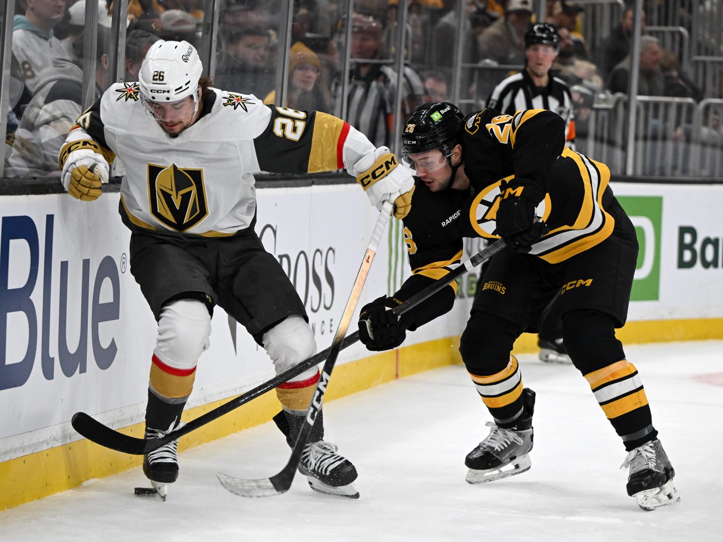 Vegas Golden Knights forward Alexander Holtz battles Boston Bruins defenseman Andrew Peeke for the puck along the boards