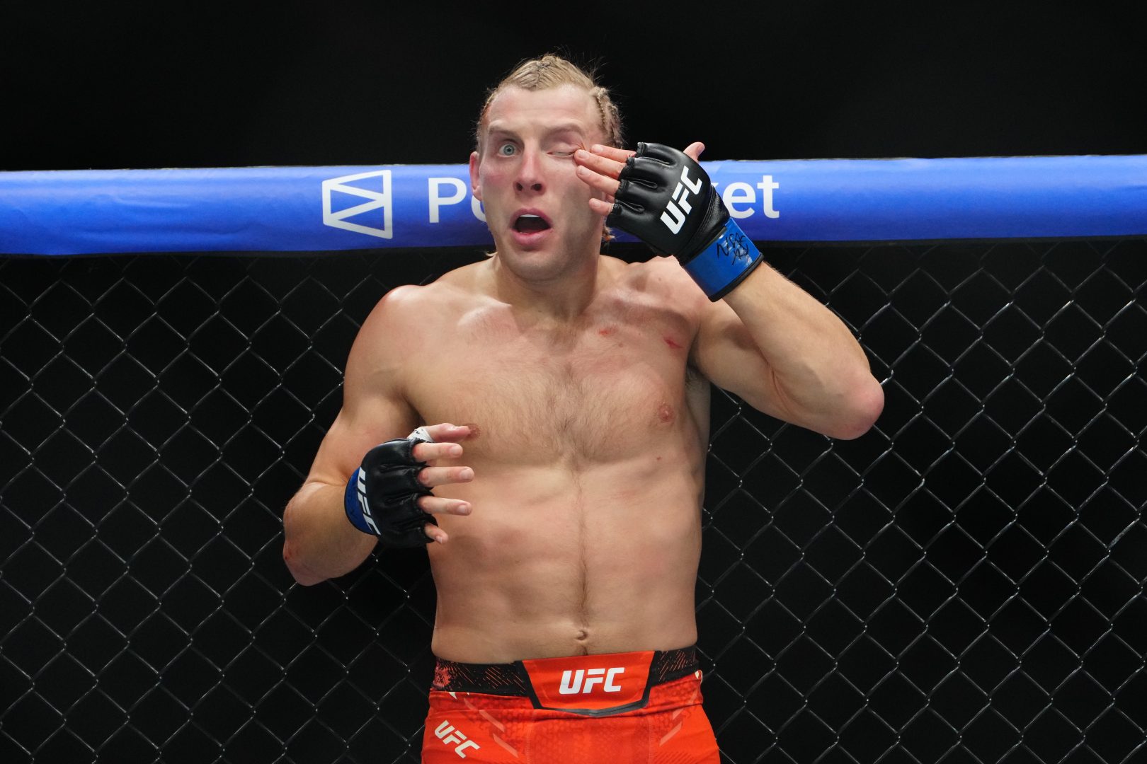 Paddy Pimblett (blue gloves) reacts in the fight against Justin Gaethje (red gloves) during UFC 324 at T-Mobile Arena.