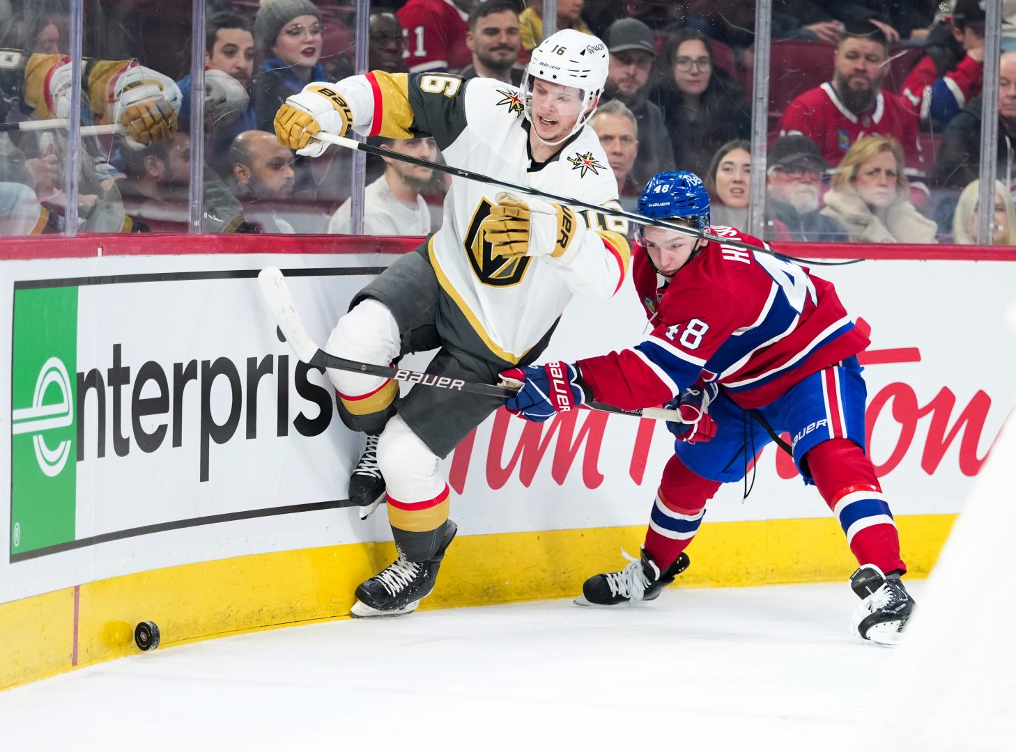 Vegas Golden Knights forward Pavel Dorofeyev (16) protects the puck along the boards as Montreal Canadiens defenseman Lane Hutson (48) checks him at Bell Centre.