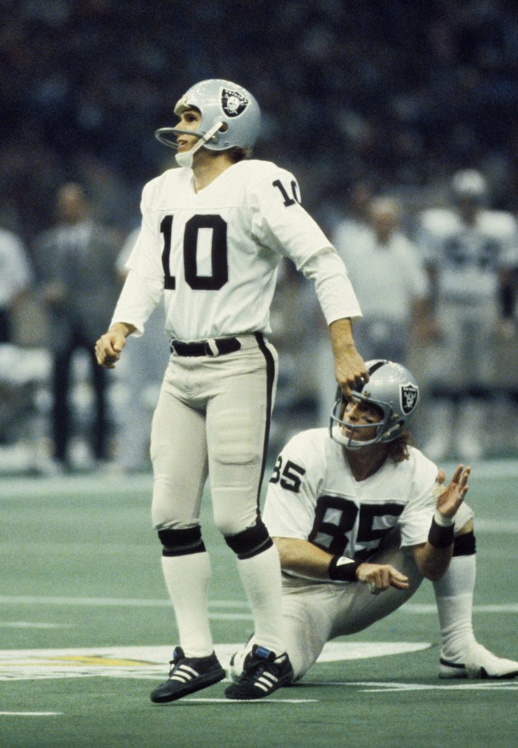 File photo: Oakland Raiders kicker Chris Bahr stands on the field with receiver Bob Chandler during Super Bowl XV.