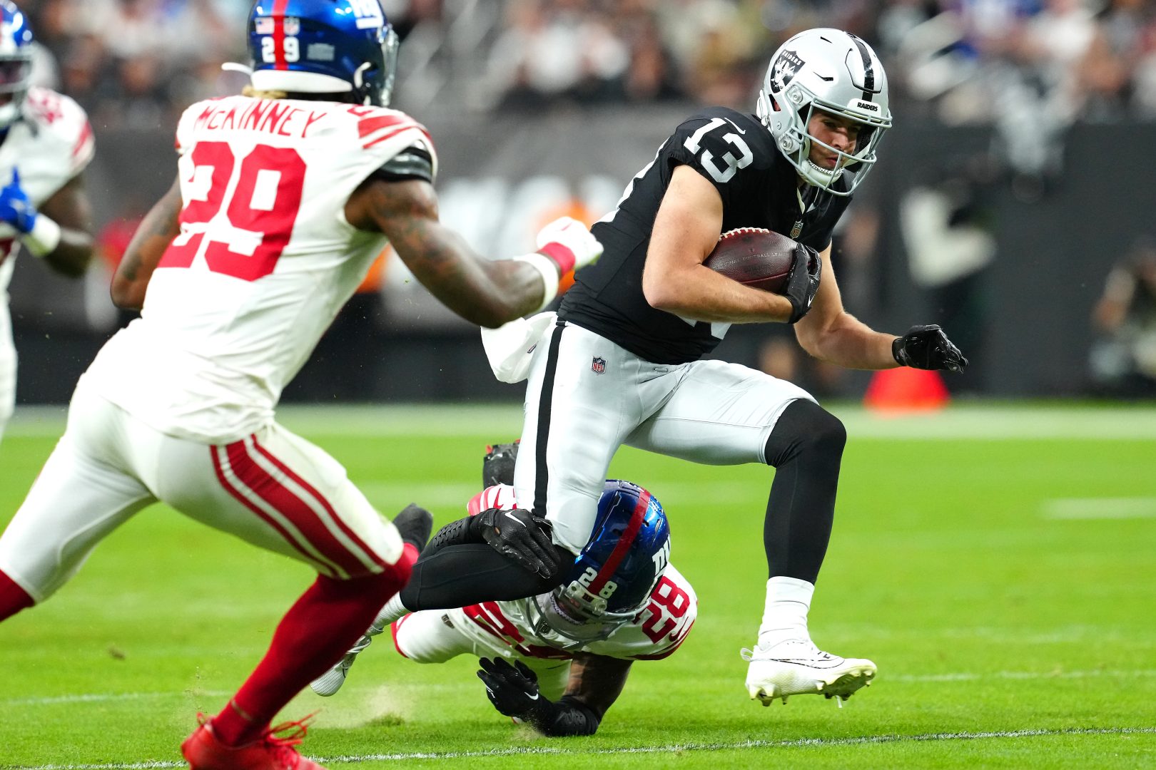 File photo: Las Vegas Raiders wide receiver Hunter Renfrow eludes a tackle attempt at Allegiant Stadium.
