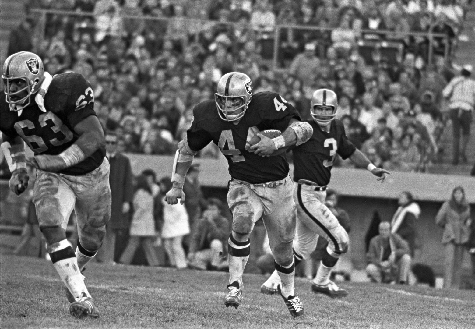 File photo: Oakland Raiders running back Marv Hubbard (44) follows a block by guard Gene Upshaw (63) against the Kansas City Chiefs at Oakland Coliseum.