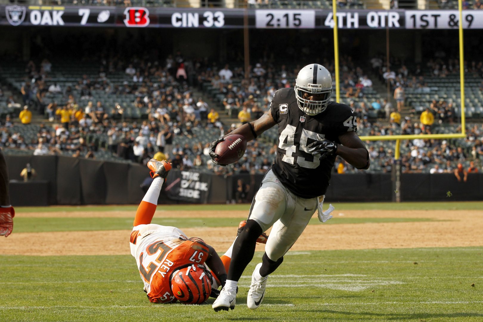 File photo: Oakland Raiders fullback Marcel Reece (45) scores a fourth-quarter touchdown past Bengals linebacker Vincent Rey (57) at O.co Coliseum.
