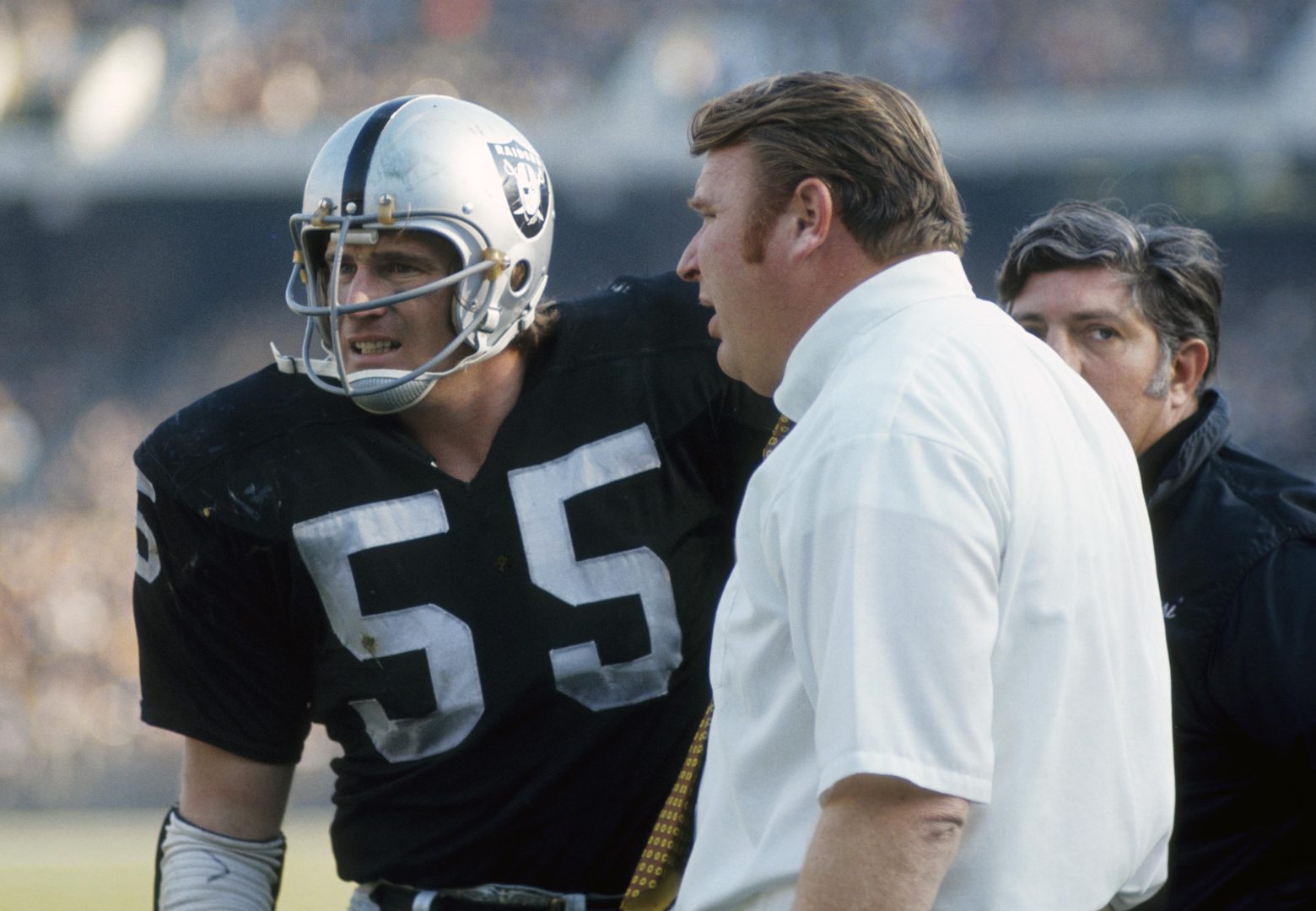 File photo: Oakland Raiders linebacker Dan Conners (55) talks with head coach John Madden on the sideline at Oakland Coliseum.