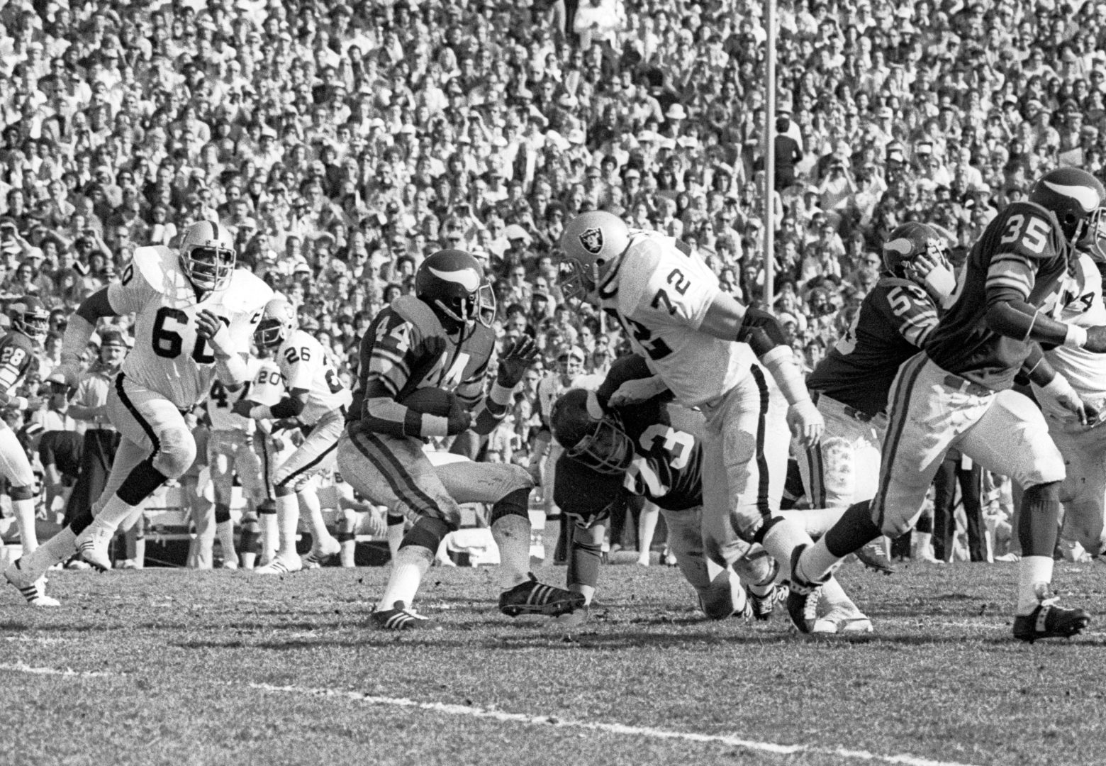 File photo: Oakland Raiders defensive end Otis Sistrunk (60) closes on Vikings running back Chuck Foreman (44) in Super Bowl XI at the Rose Bowl.