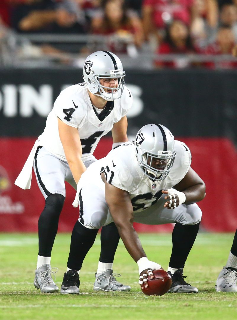 File photo: Oakland Raiders center Rodney Hudson (61) snaps to quarterback Derek Carr (4) during a preseason game at University of Phoenix Stadium.