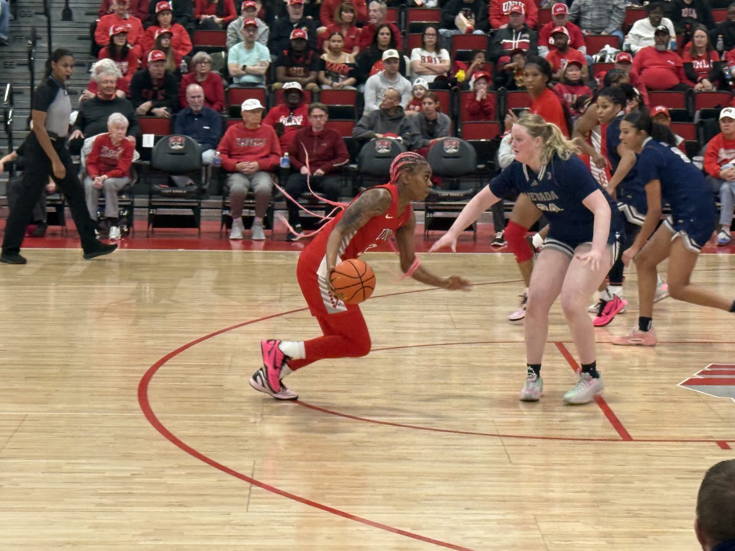 UNLV guard Shelbee Brown dribbles toward the lane while a Nevada defender slides in front of her during a game at The Pavilion.