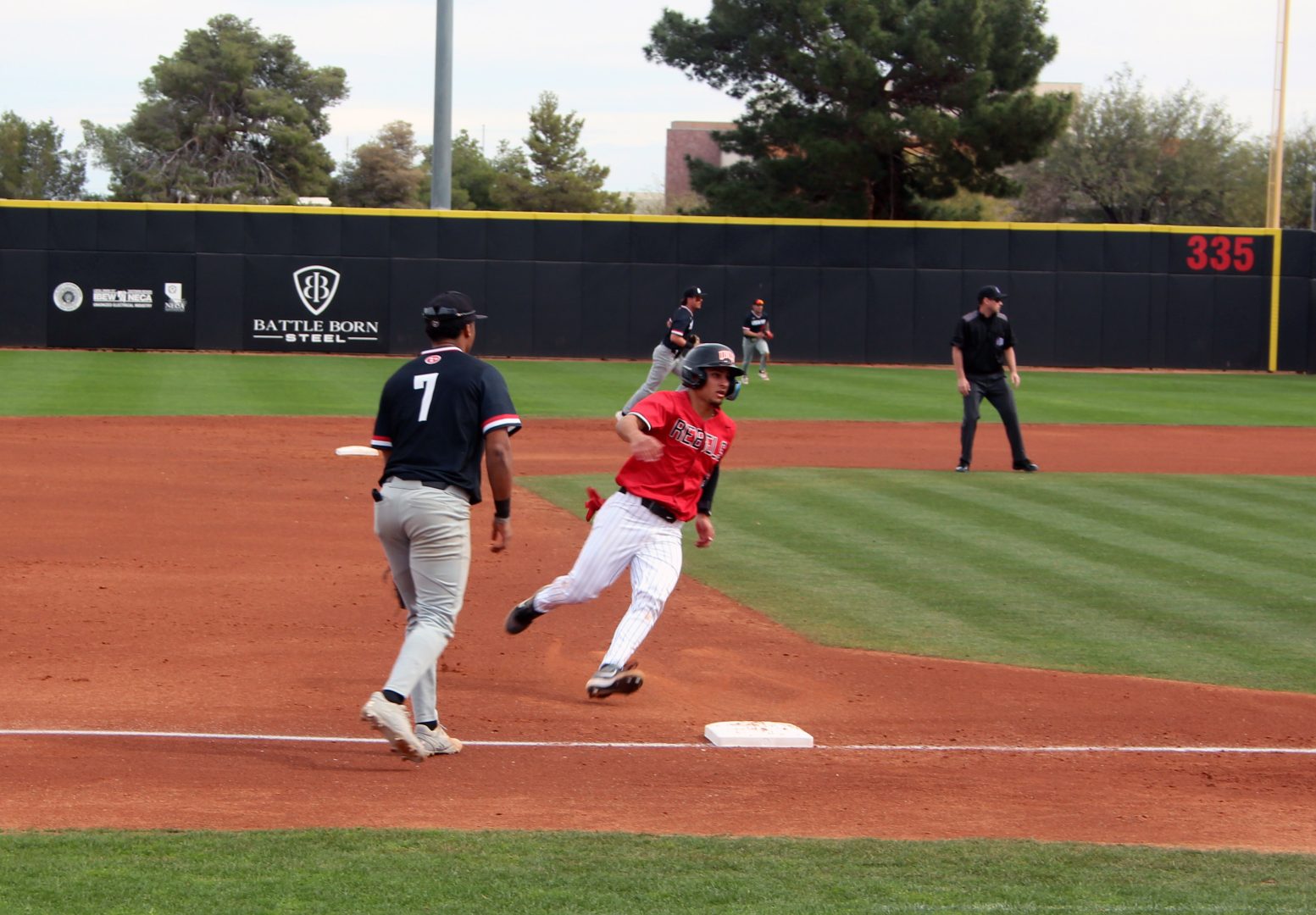 UNLV runner Marcos Rosales rounds third base toward home at Earl E. Wilson Stadium.