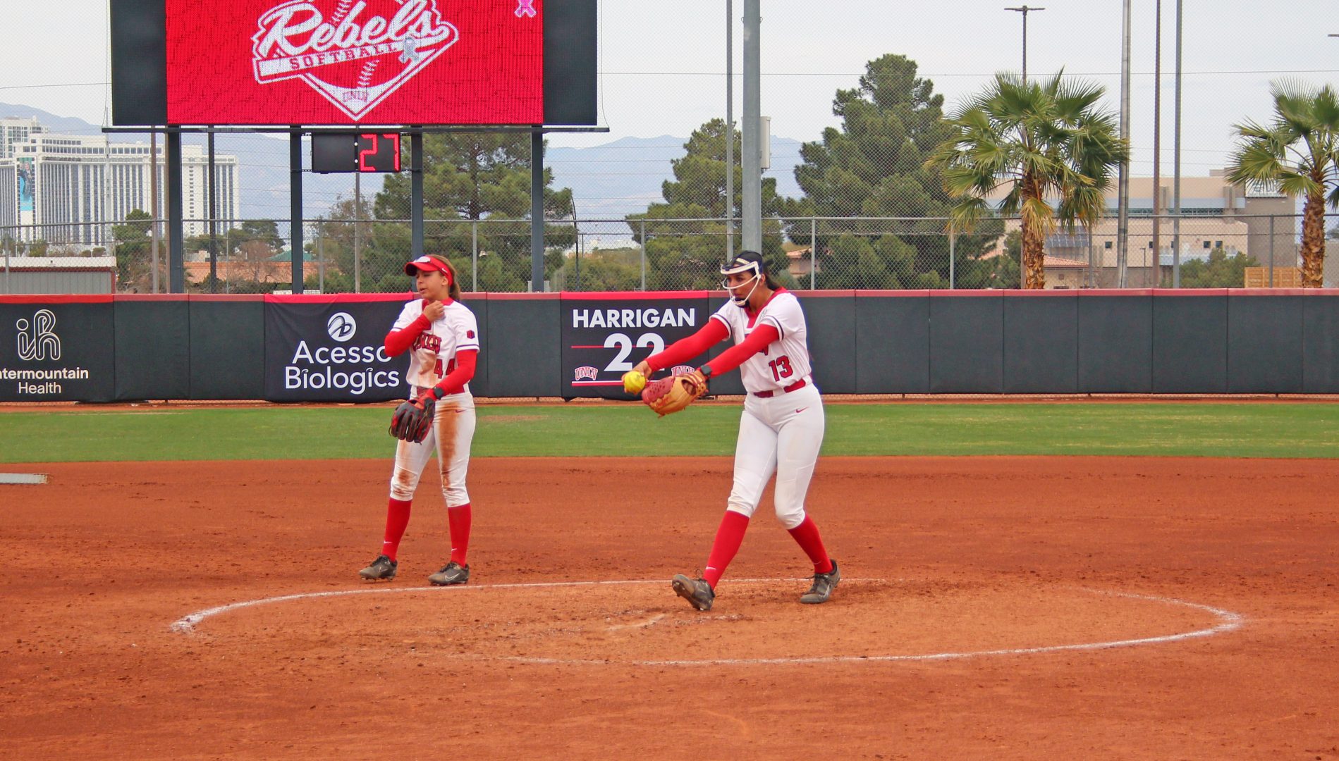 UNLV pitcher Yanina Sherwood (13) warms up between innings in the circle as infielder Rachel Cook (44) watches at Eller Media Stadium.