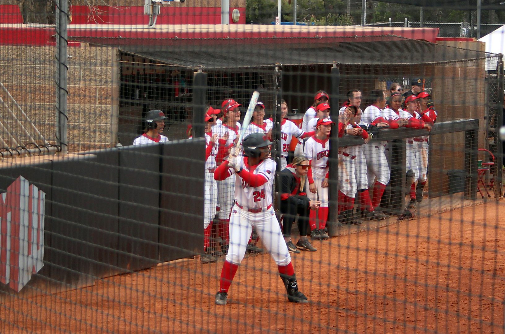 UNLV softball senior Bri Williams batting near the dugout during Rebel Classic action at Eller Media Stadium in Las Vegas.