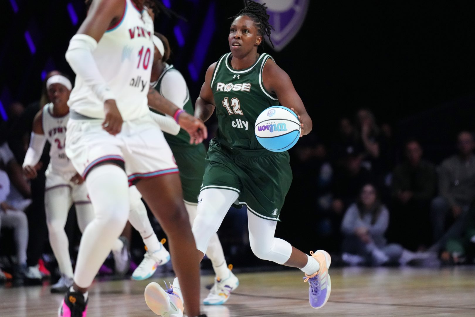 Chelsea Gray (12) of the Rose brings the ball up the court against the Vinyl during the second half of the Unrivaled women’s professional 3v3 basketball league at Wayfair Arena.