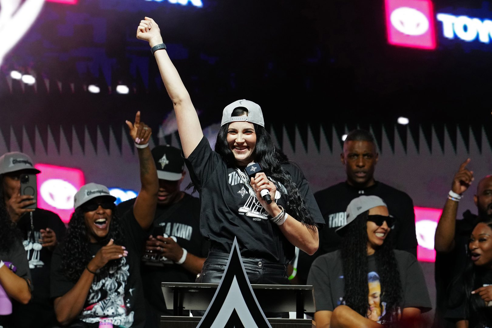 Megan Gustafson, wearing a Las Vegas Aces jersey, talks with fans at Toshiba Plaza during the 2025 WNBA championship celebration in Las Vegas.