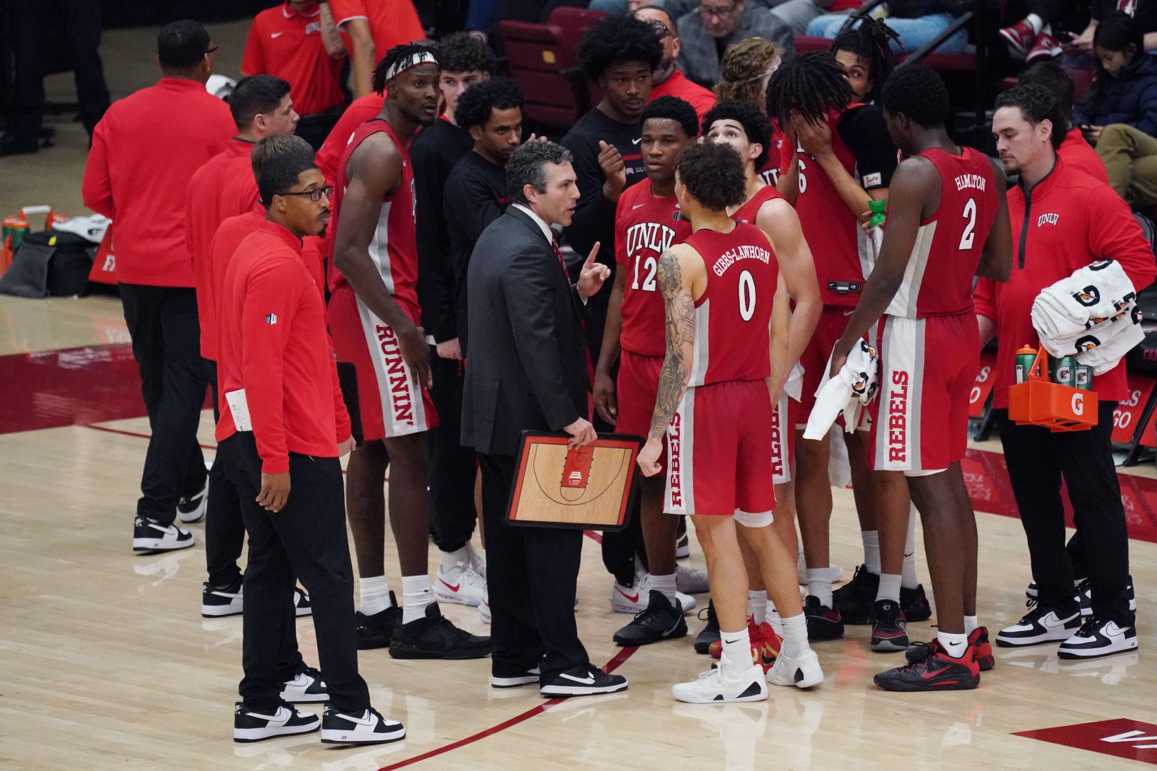 UNLV Runnin' Rebels head coach Josh Pastner talks with his team during a timeout in the second half against the Stanford Cardinal at Maples Pavilion.