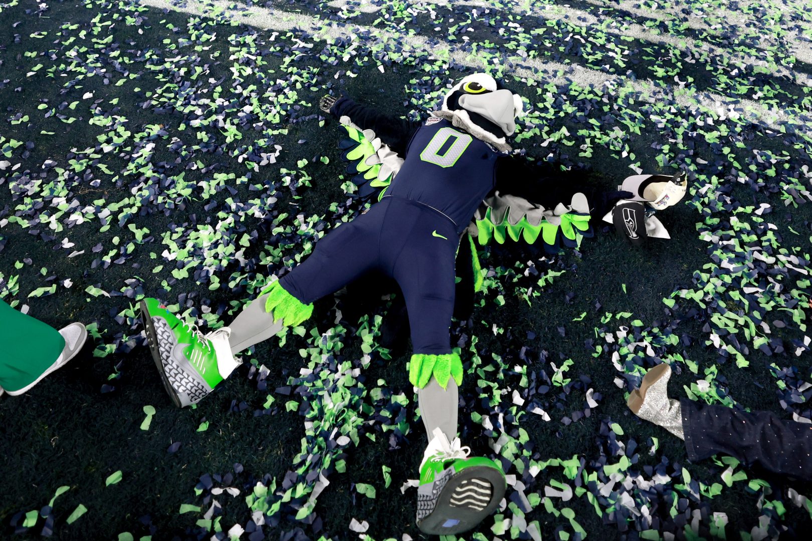 Seattle Seahawks mascot Blitz lies in green and blue confetti on the field after Super Bowl LX at Levi’s Stadium in Santa Clara.