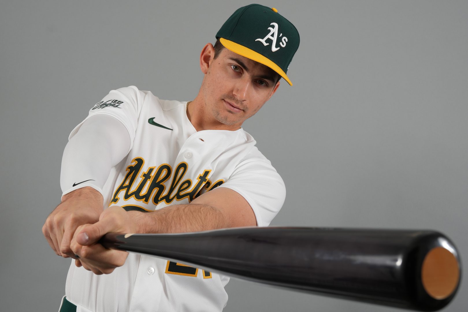 Athletics outfielder Tyler Soderstrom poses with a bat during photo day at Hohokam Stadium in Mesa, Arizona.