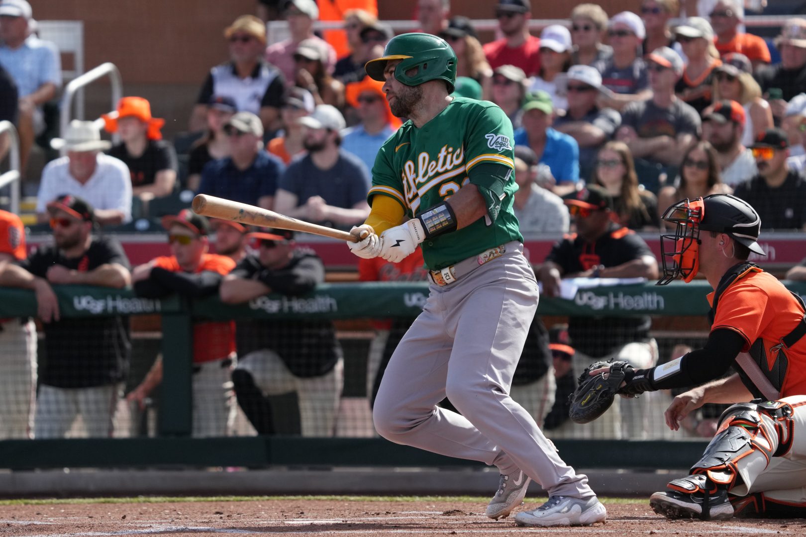 Athletics catcher Austin Wynns hits a first-inning single against the Giants at Scottsdale Stadium.