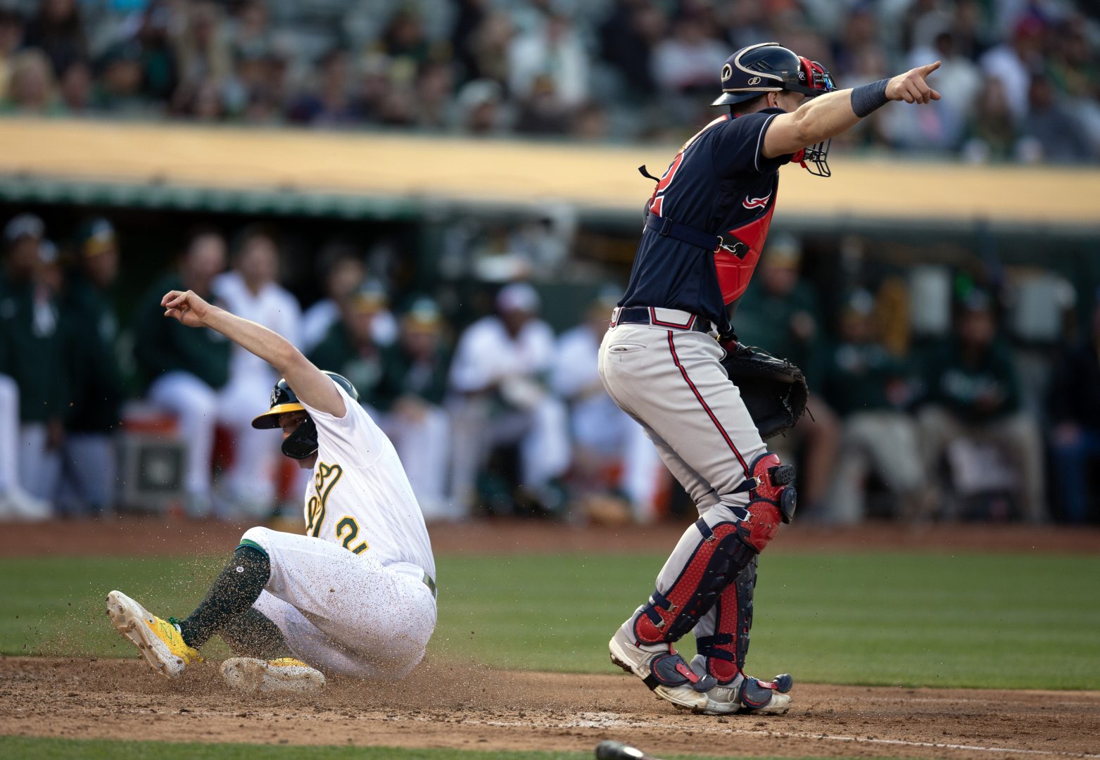 Athletics catcher Sean Murphy signals a relay to first as Nick Allen scores on an infield single by Shea Langeliers during the eighth inning at Oakland-Alameda County Coliseum in Oakland.
