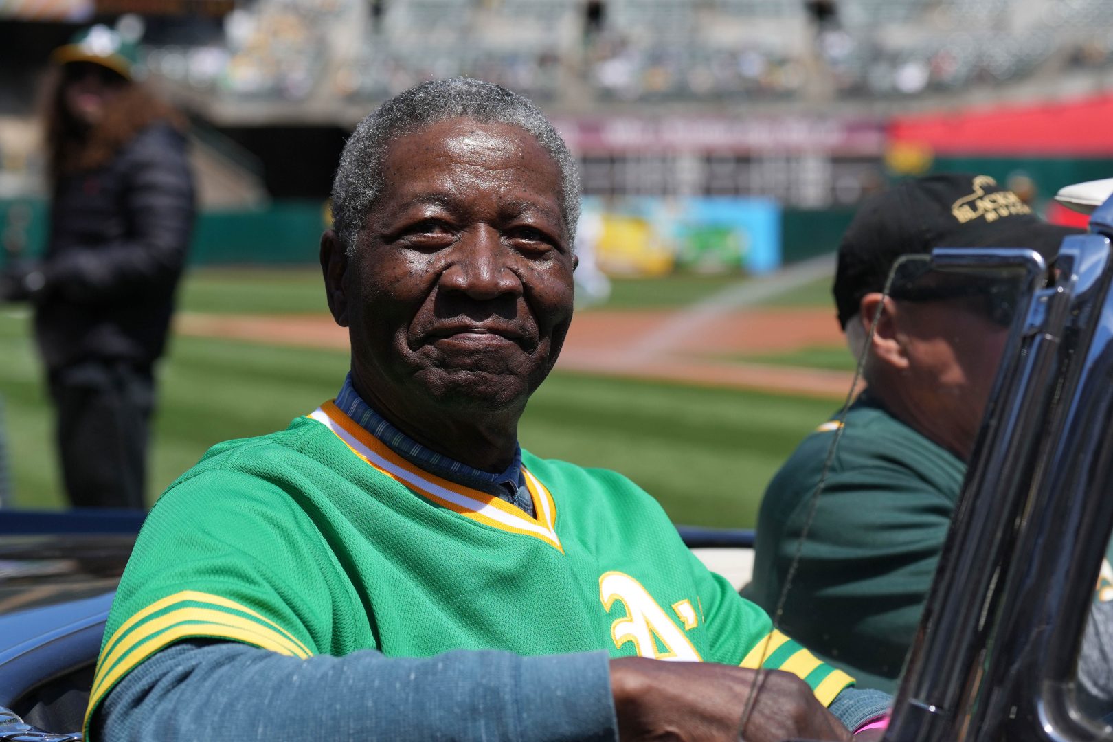 Athletics former pitcher Johnny Blue Moon Odom rides in a car on the field before a game against the New York Mets at RingCentral Coliseum in Oakland.