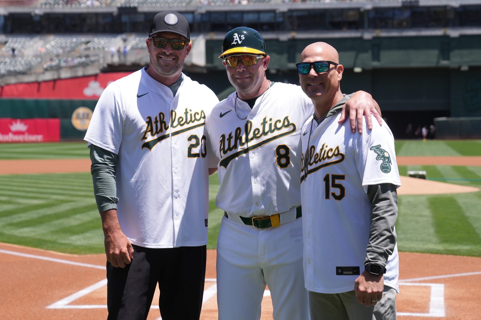 Athletics first base coach Bobby Crosby poses with former pitchers Mark Mulder and Tim Hudson before a game against the Toronto Blue Jays at Oakland-Alameda County Coliseum in Oakland.