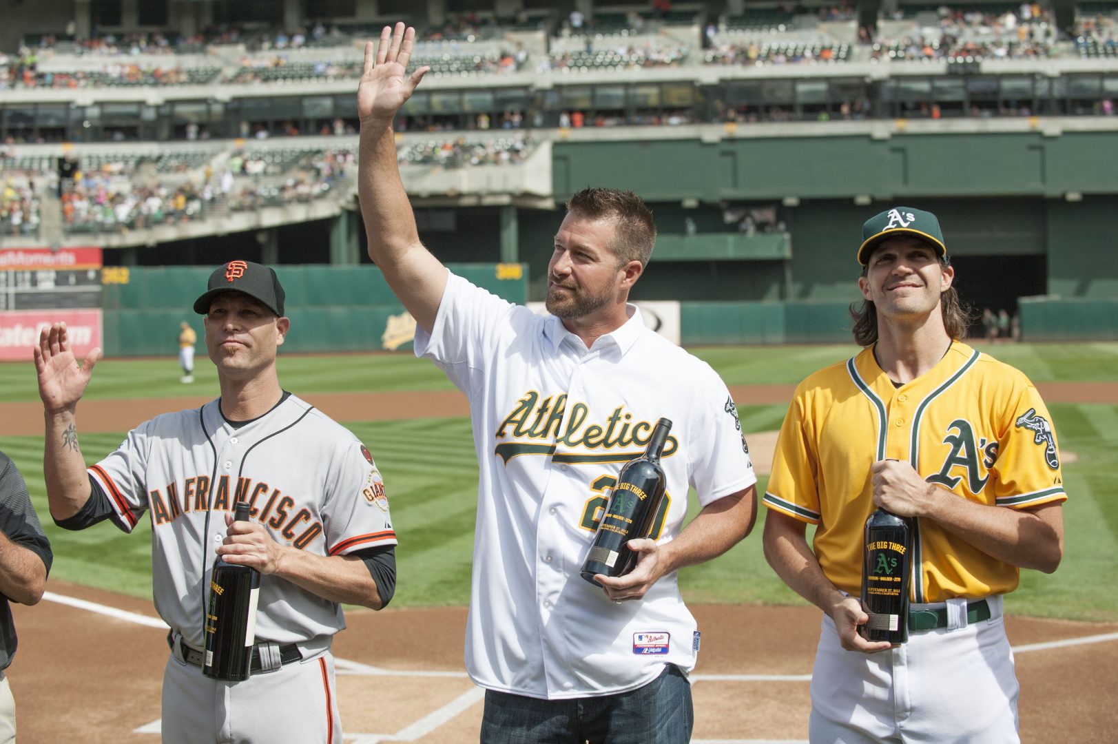 Athletics former starting pitcher Mark Mulder stands on the field as he accepts gifts before the game at O.co Coliseum in Oakland.