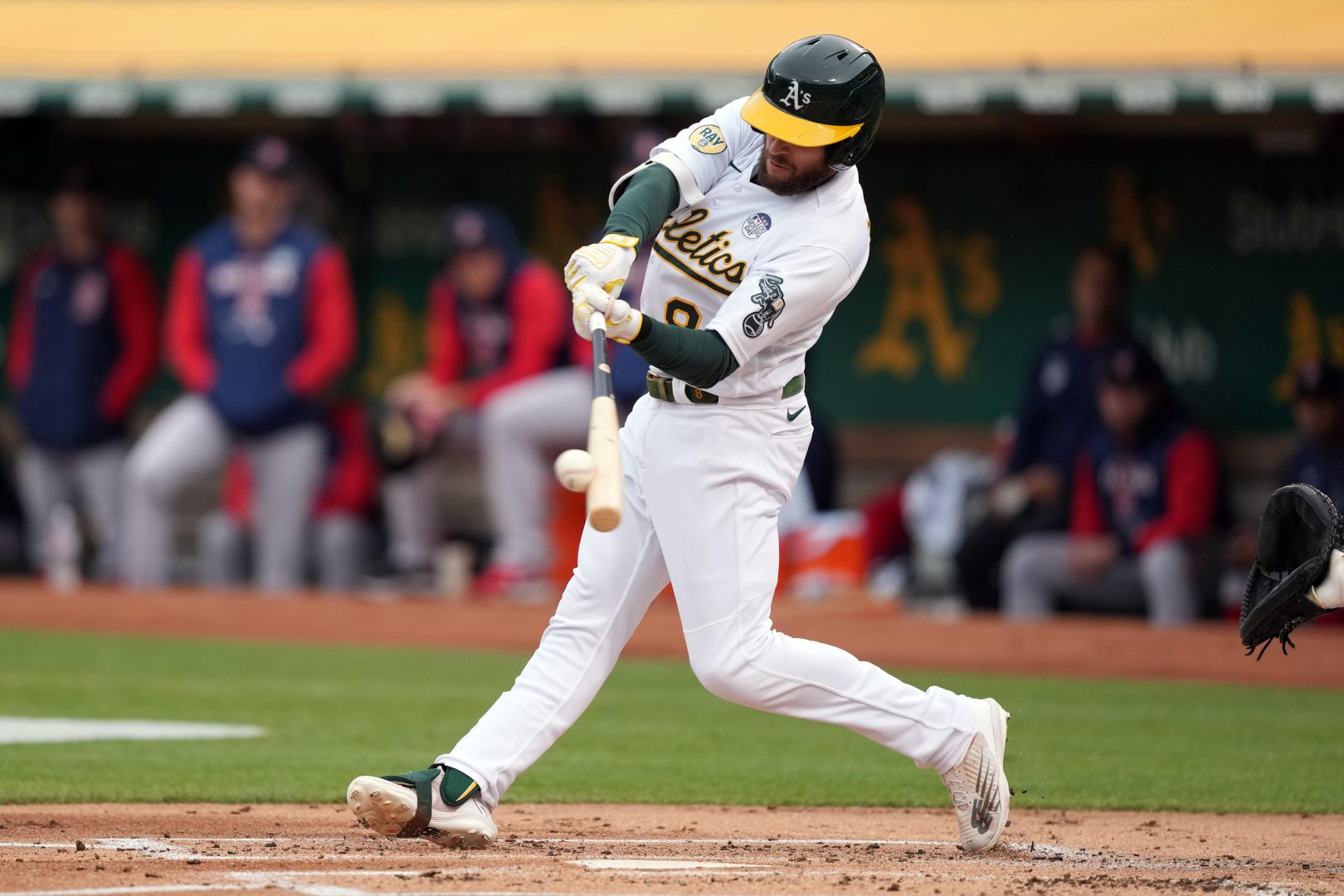 Athletics designated hitter Jed Lowrie hits a double against the Boston Red Sox during the first inning at RingCentral Coliseum in Oakland.
