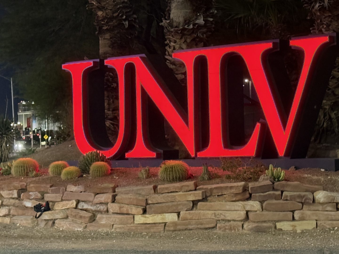 Illuminated UNLV sign outside Eller Media Stadium and Earl E. Wilson Stadium on South Maryland Parkway in Las Vegas at night.