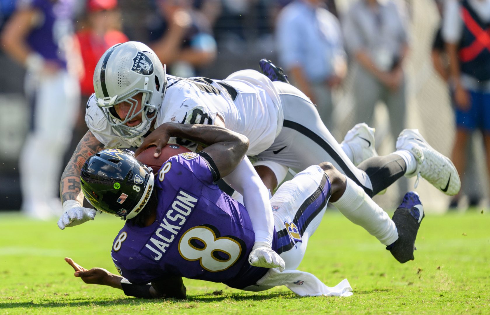 Las Vegas Raiders defensive end Maxx Crosby (98) brings down Baltimore Ravens quarterback Lamar Jackson (8) at M&T Bank Stadium.