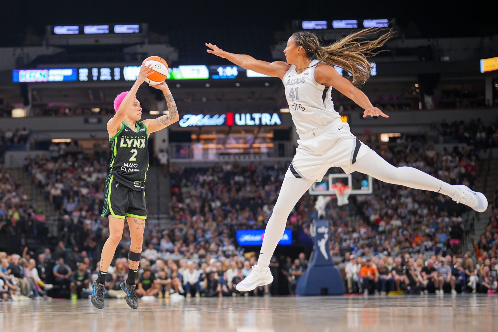 Kiah Stokes defends a shot by Natisha Hiedeman during a Las Vegas Aces vs. Minnesota Lynx game at Target Center in 2025.
