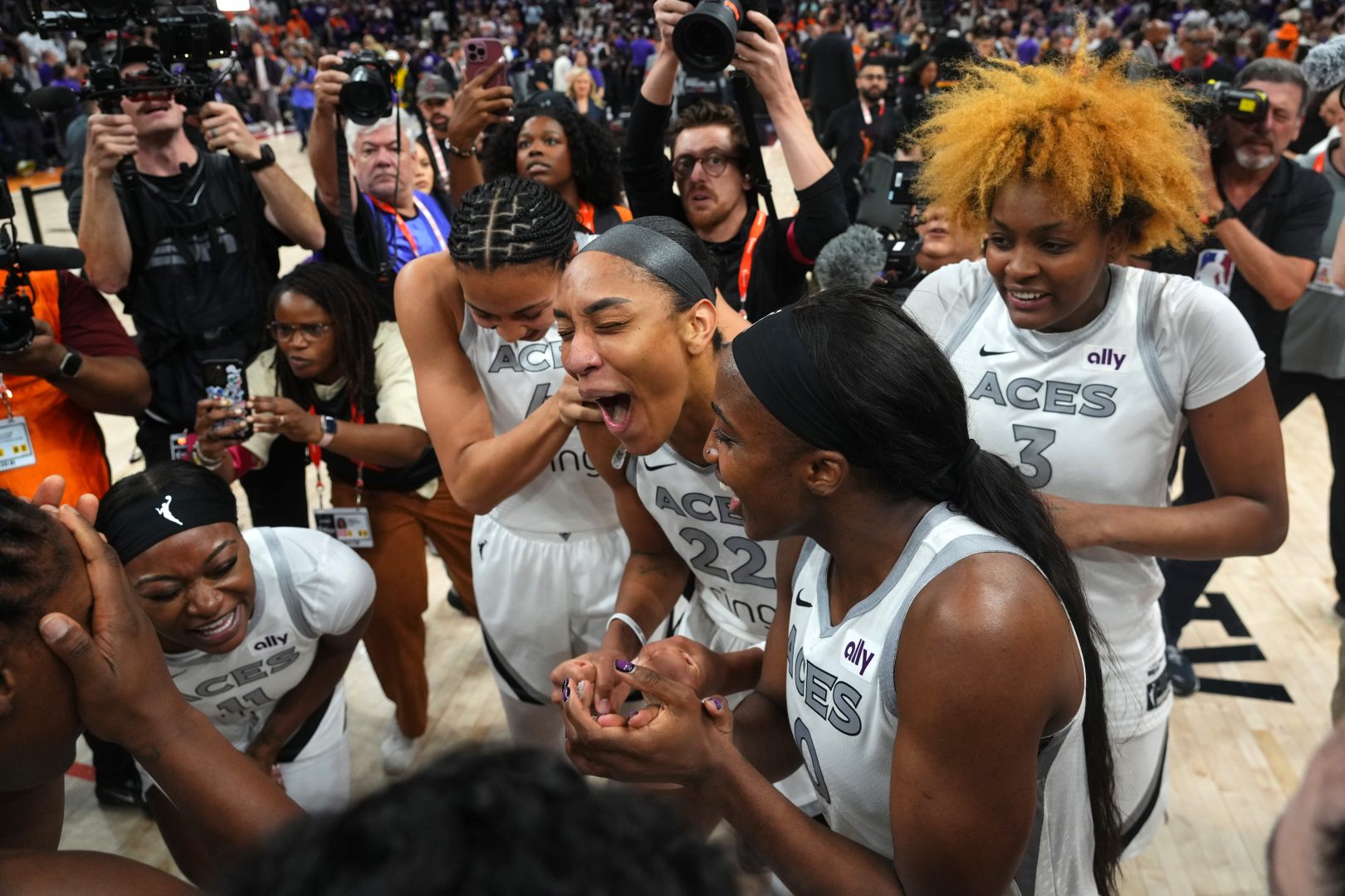 A’ja Wilson celebrates with Aces teammates after Game 4 of the 2025 WNBA Finals in Phoenix.