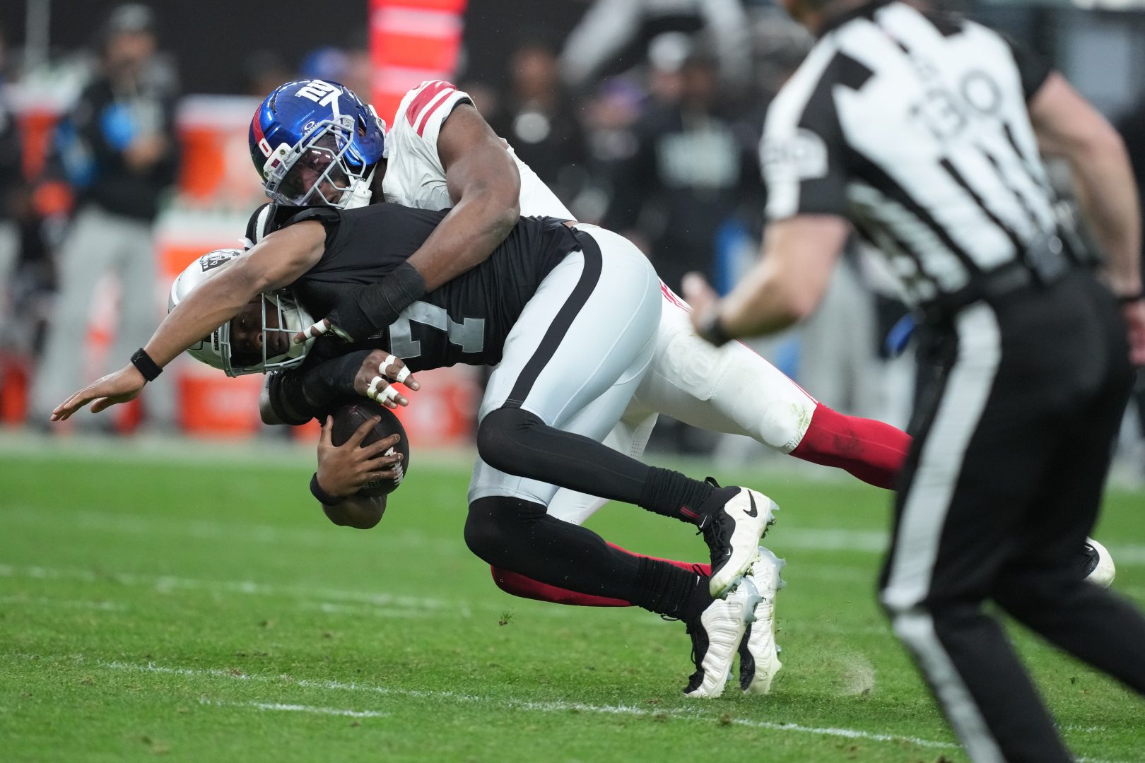 Geno Smith is tackled during a Dec. 28, 2025 Raiders game at Allegiant Stadium