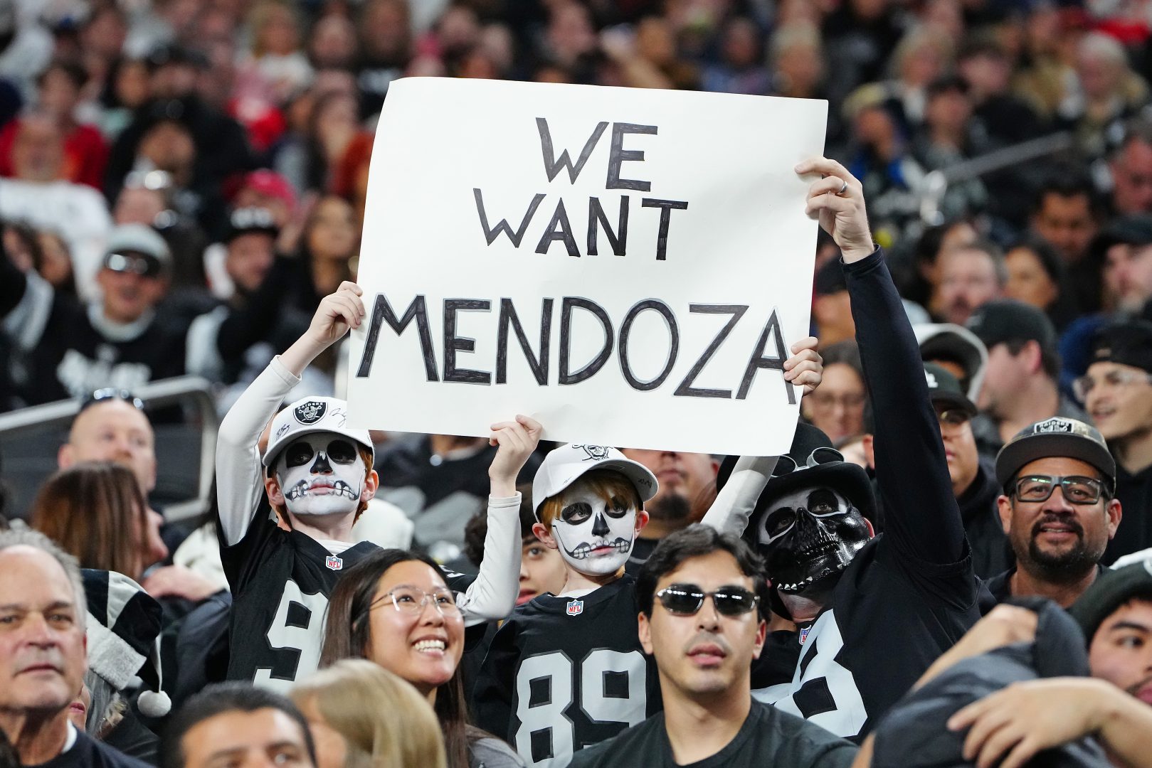 Raiders free agency fan sign at Allegiant Stadium reads We want Mendoza