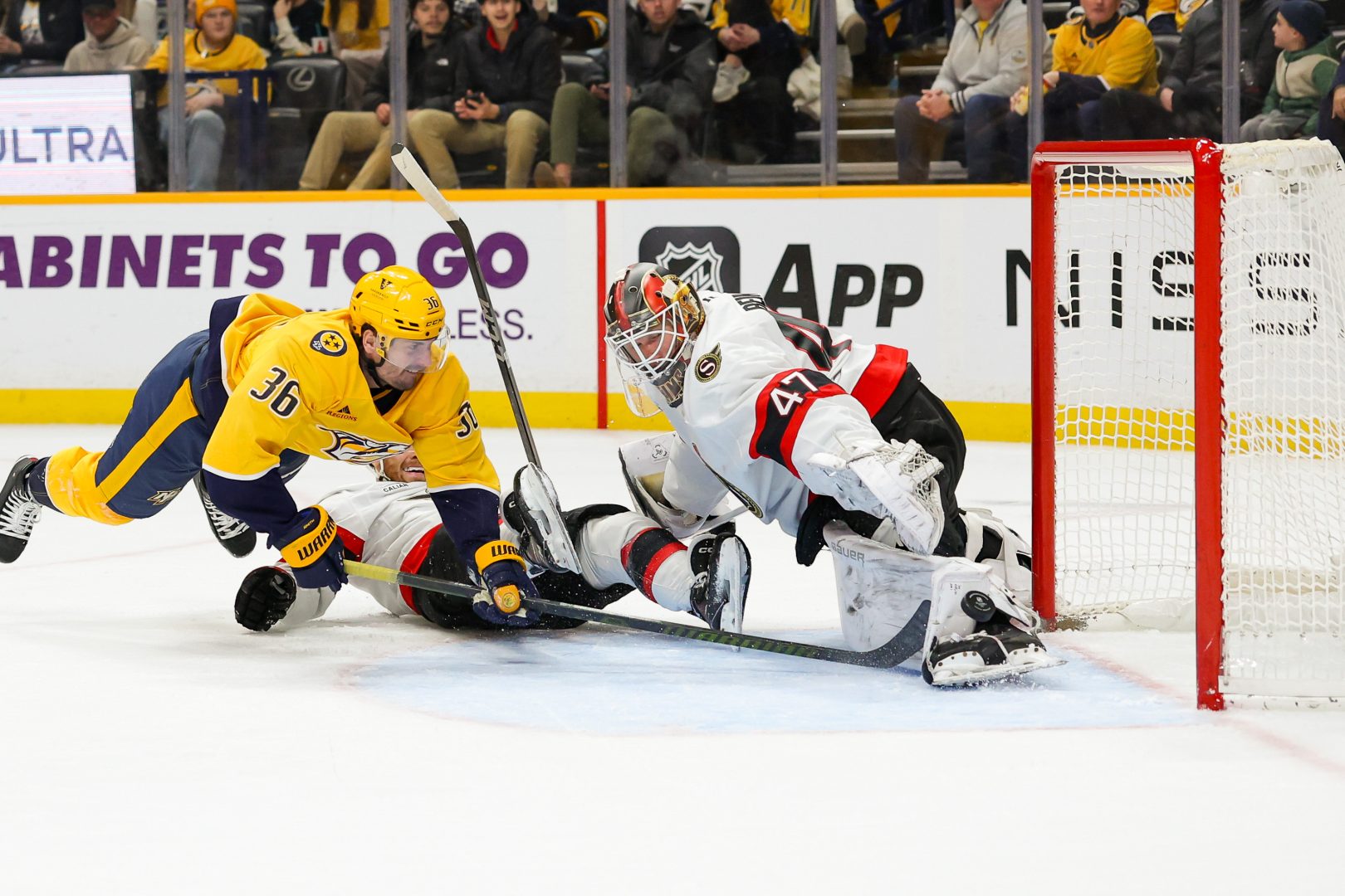 Nashville Predators forward Cole Smith reaches for a loose puck at the crease against Ottawa.