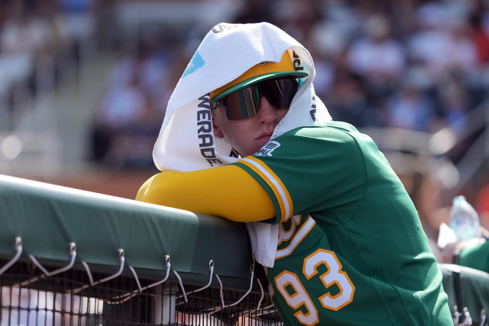 Athletics outfielder Ryan Lasko leans on the dugout railing before a game against the Giants at Scottsdale Stadium.