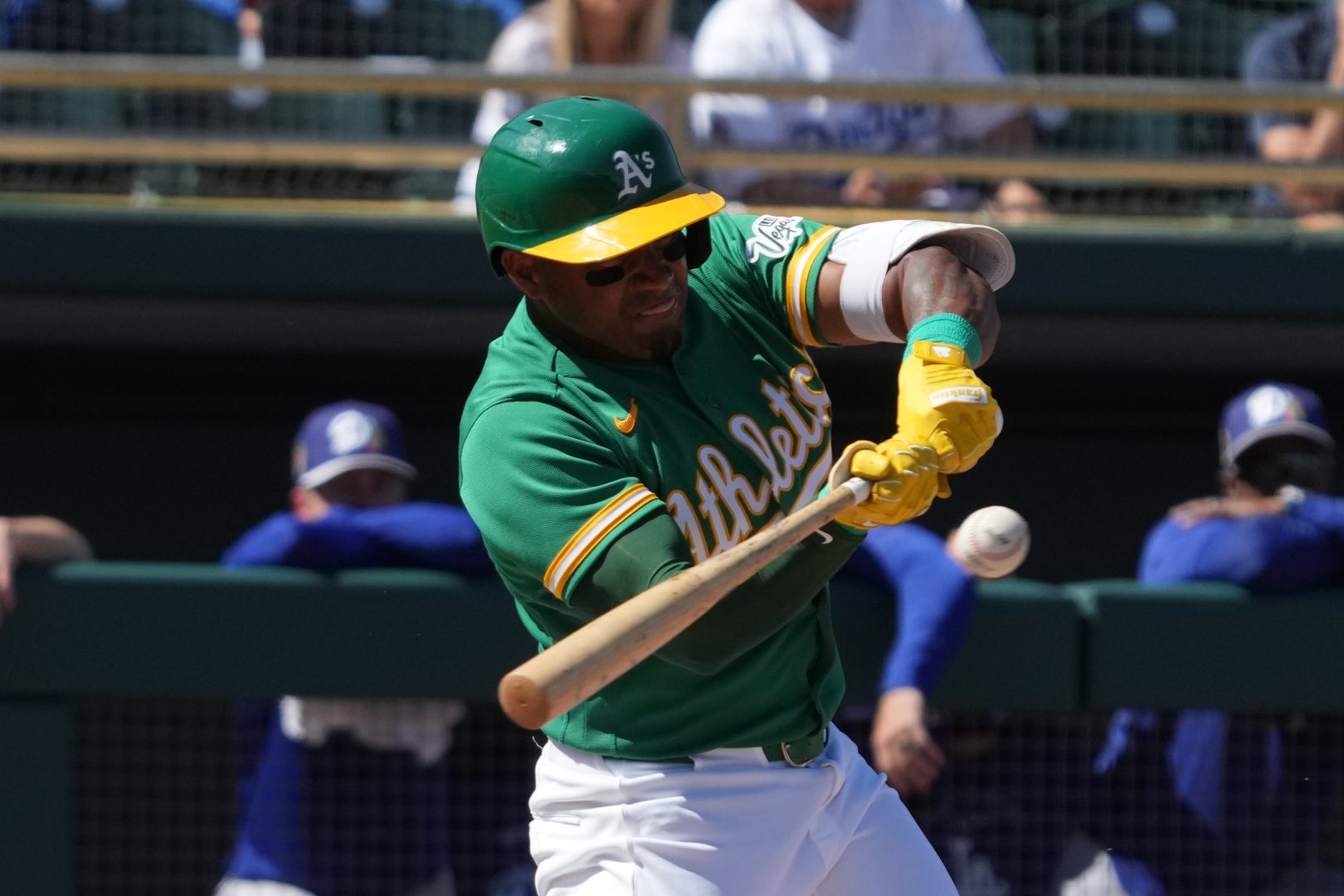 Athletics infielder Andy Ibáñez swings through contact during an at-bat against the Los Angeles Dodgers in a spring training game at Hohokam Stadium in Mesa, Arizona.