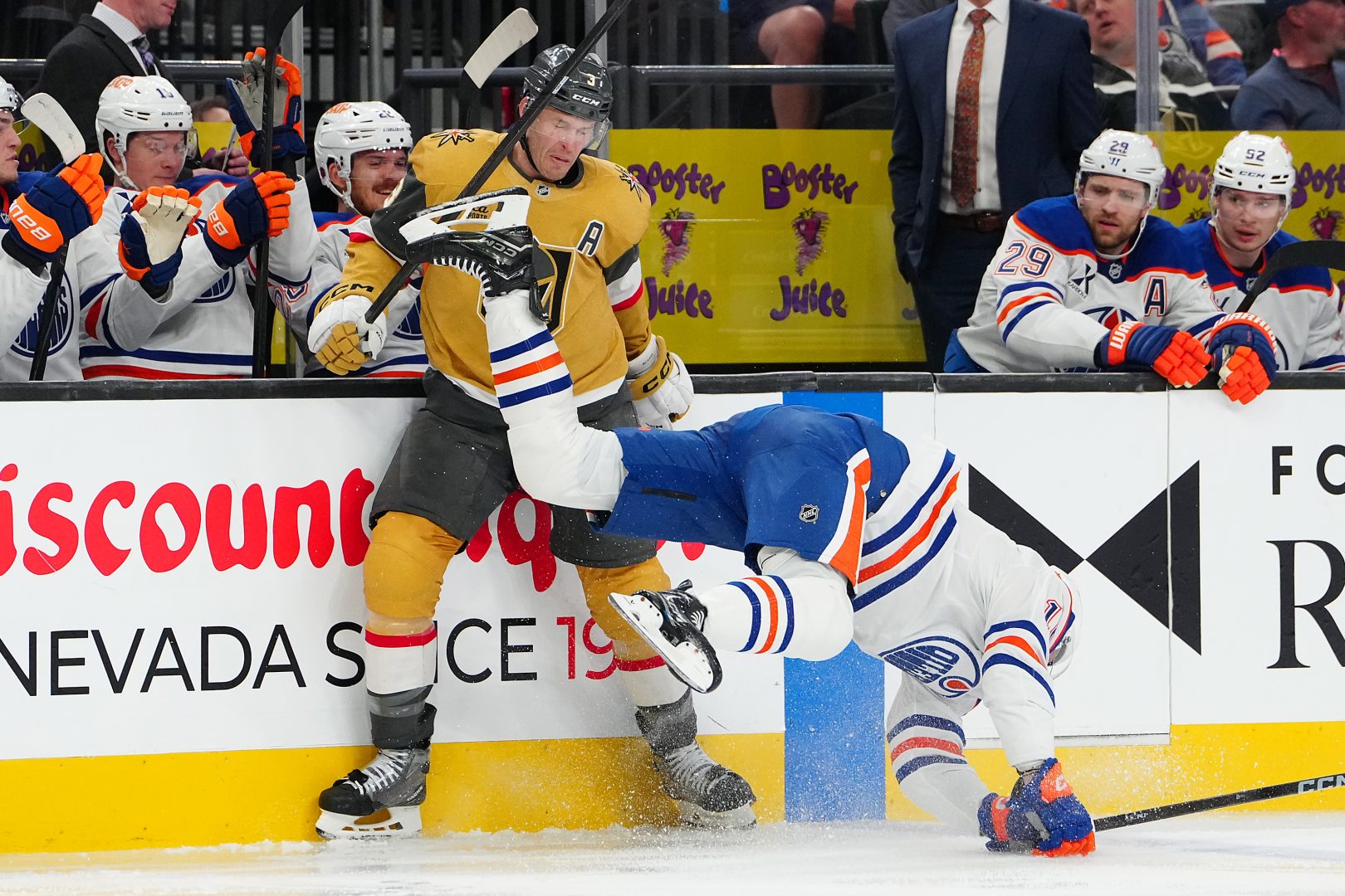 Oilers center Jason Dickinson (16) falls into the boards in front of Vegas Golden Knights defenseman Brayden McNabb (3) during the second period at T-Mobile Arena on March 8, 2